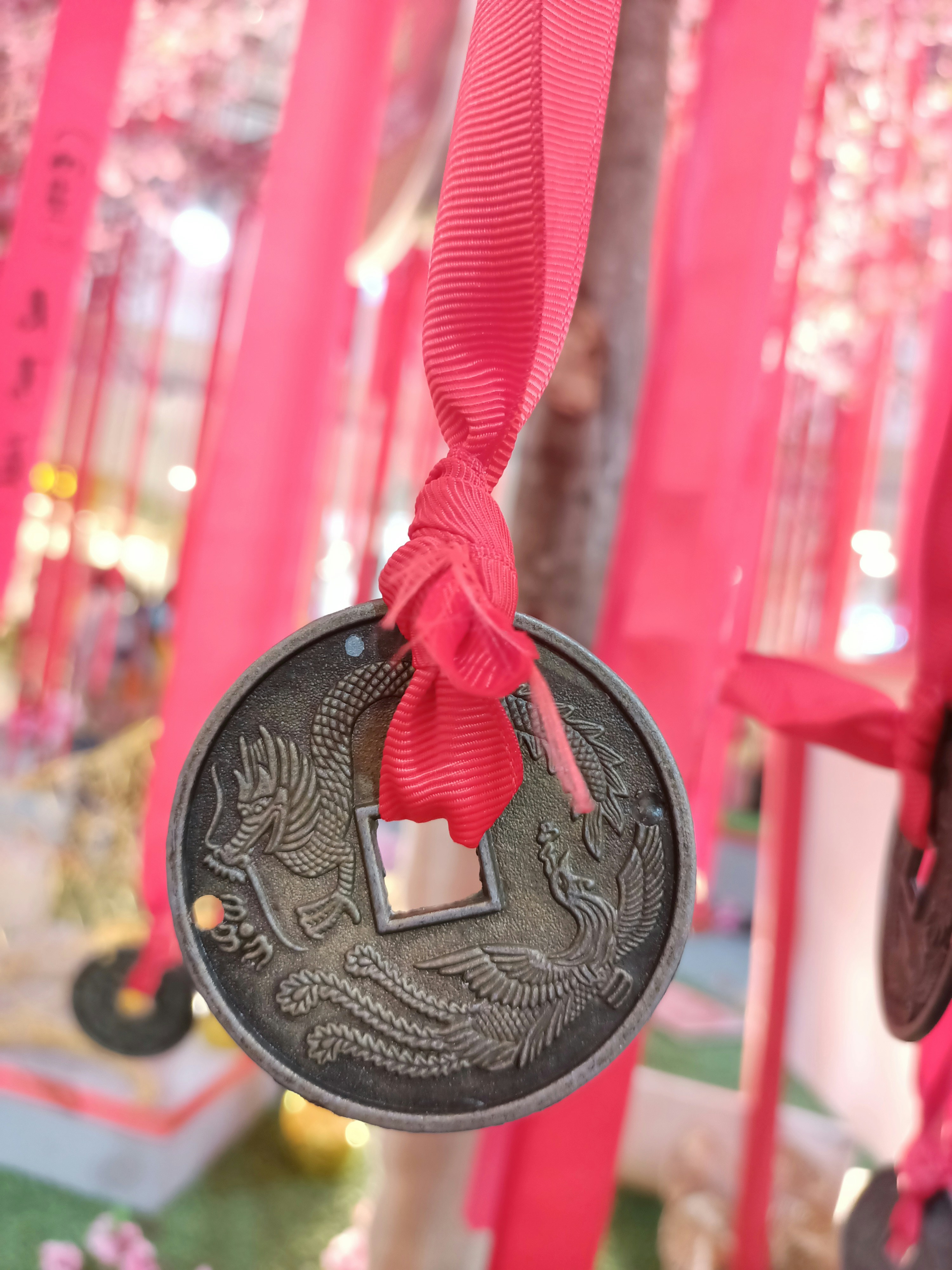 A close up of a medal hanging from a tree