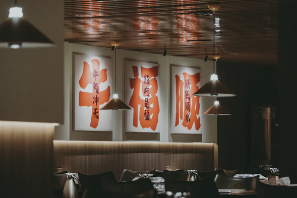 A restaurant with posters hanging from the ceiling