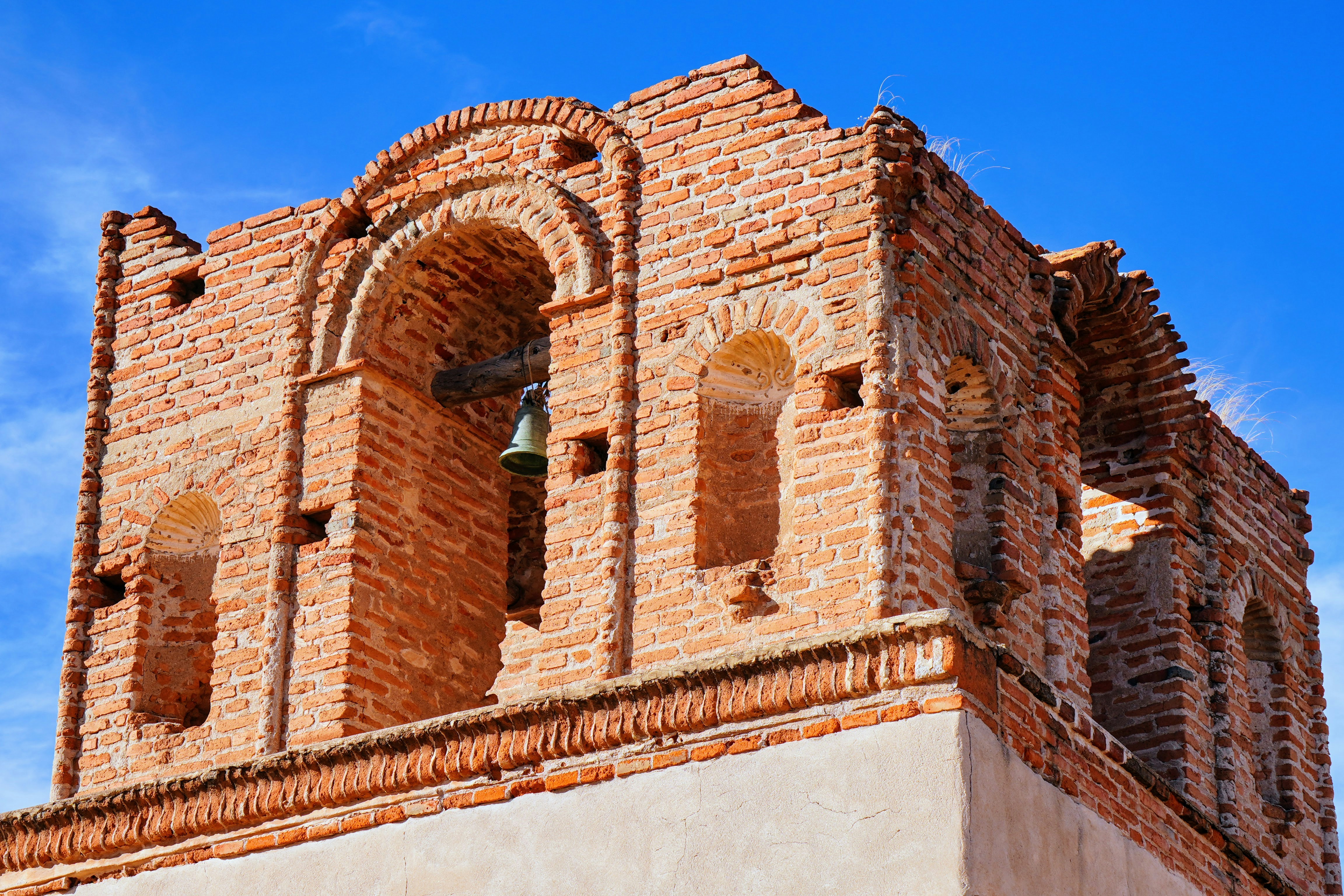 A tall brick tower with a clock on it