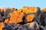 A pile of rocks with a tree in the background