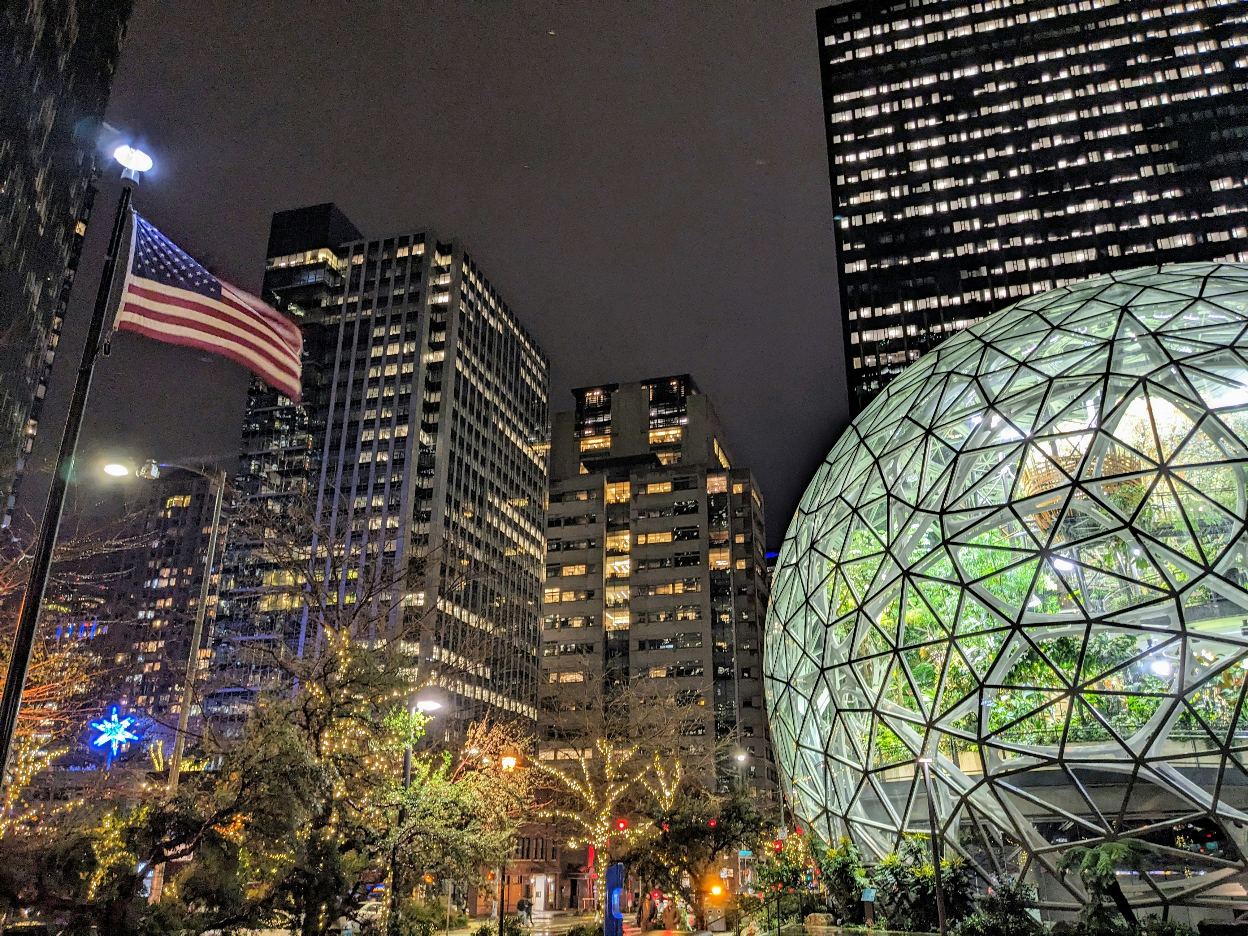 A large ball in the middle of a city at night