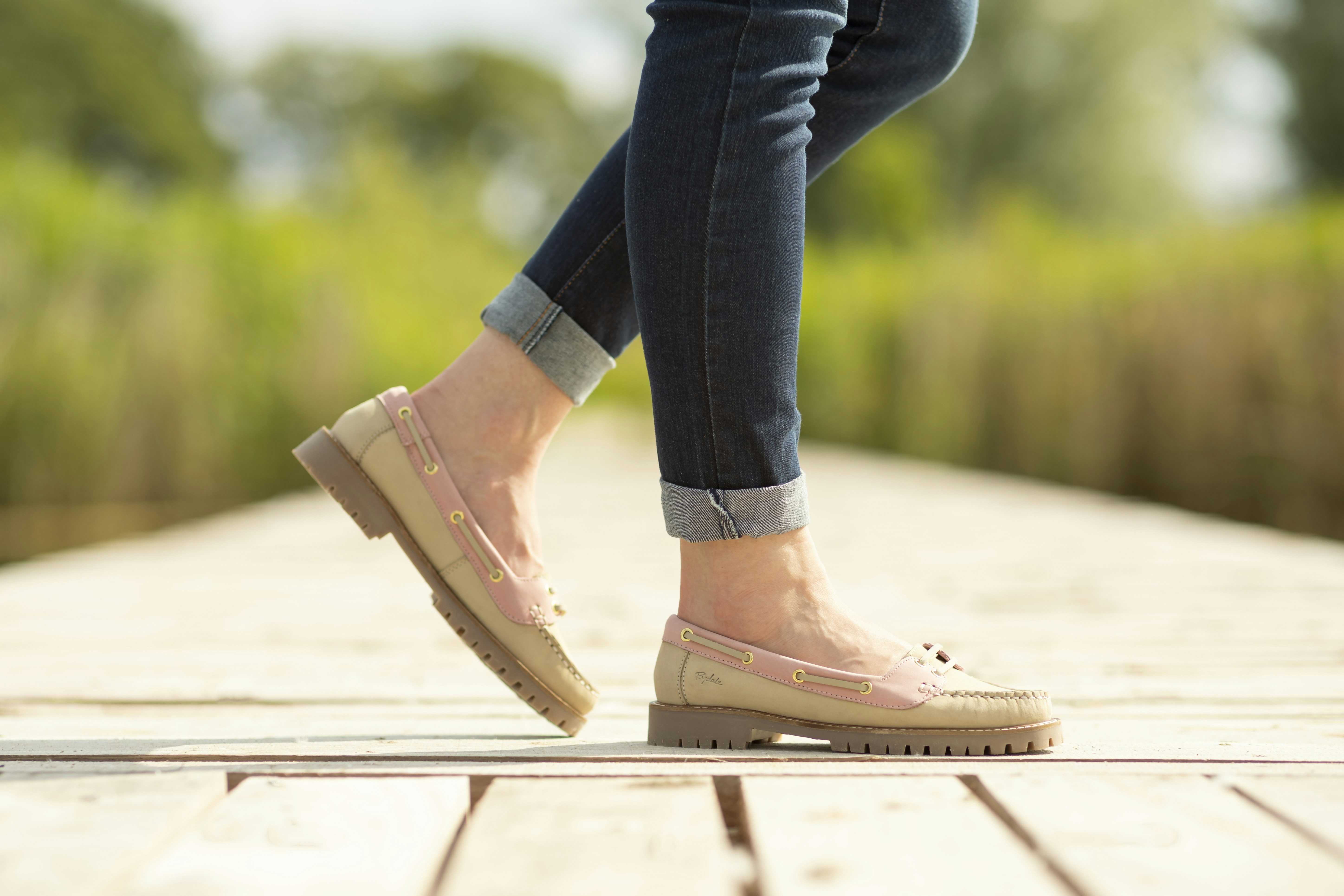 A person walking on a wooden platform in a park