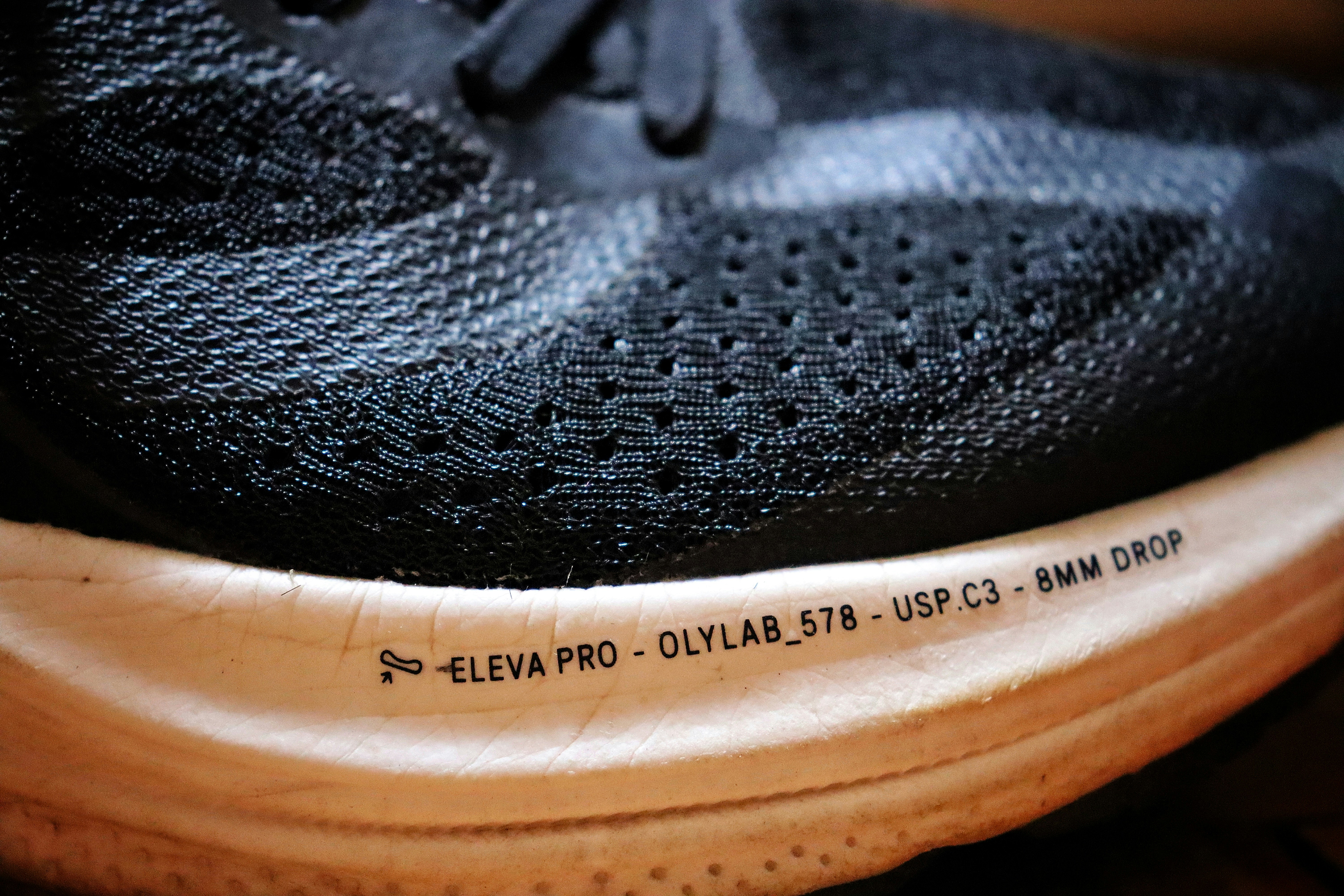 flexing a shoe midsole to show plush foam and wide forefoot - cushioned wide toe box shoes