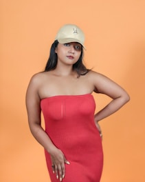 A woman in a red dress and a yellow hat