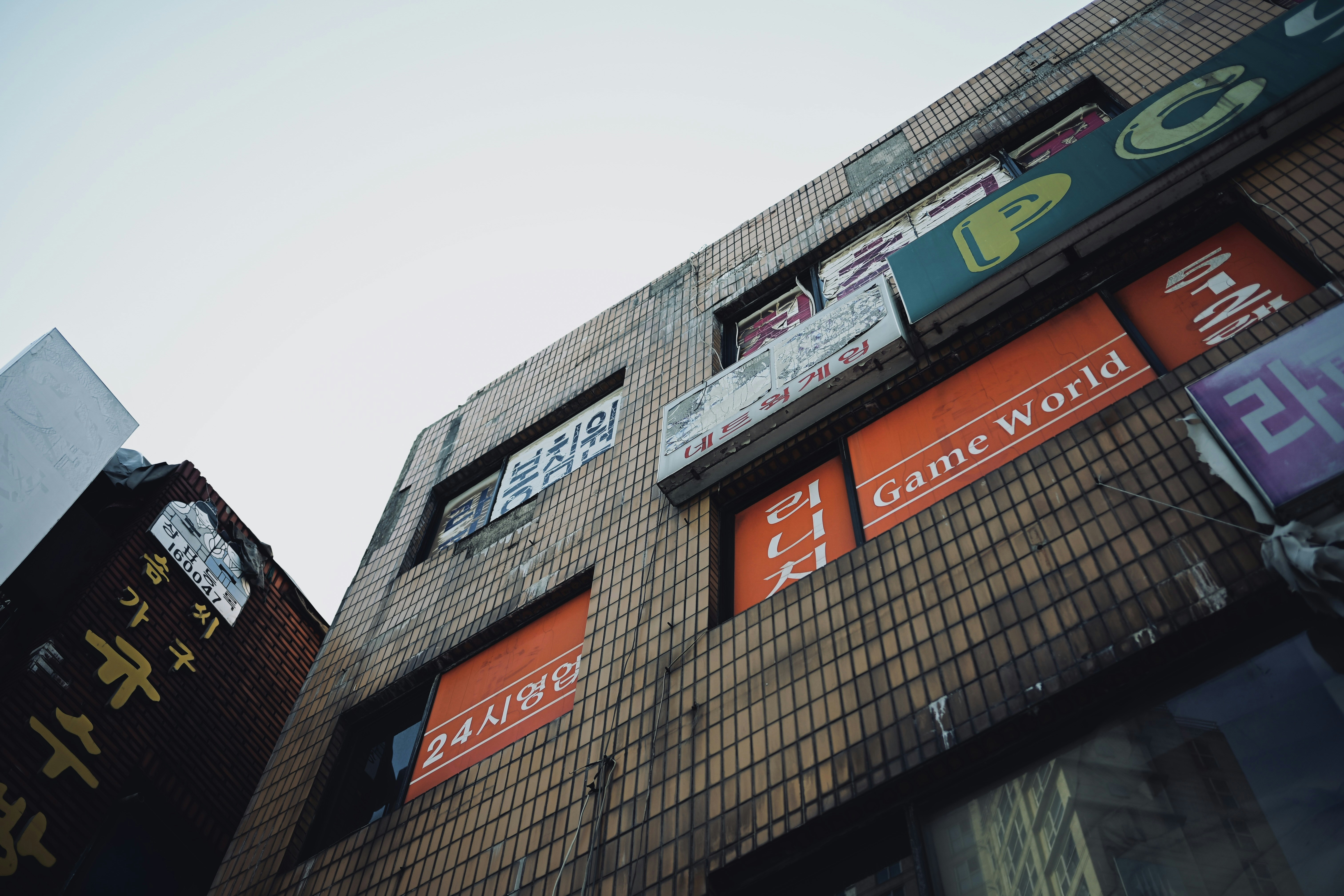 A tall building with lots of signs on the side of it