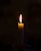 A lit candle sitting on top of a table