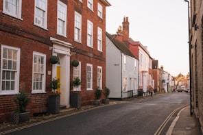 A street lined with brick buildings next to tall buildings
