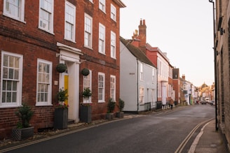 A street lined with brick buildings next to tall buildings