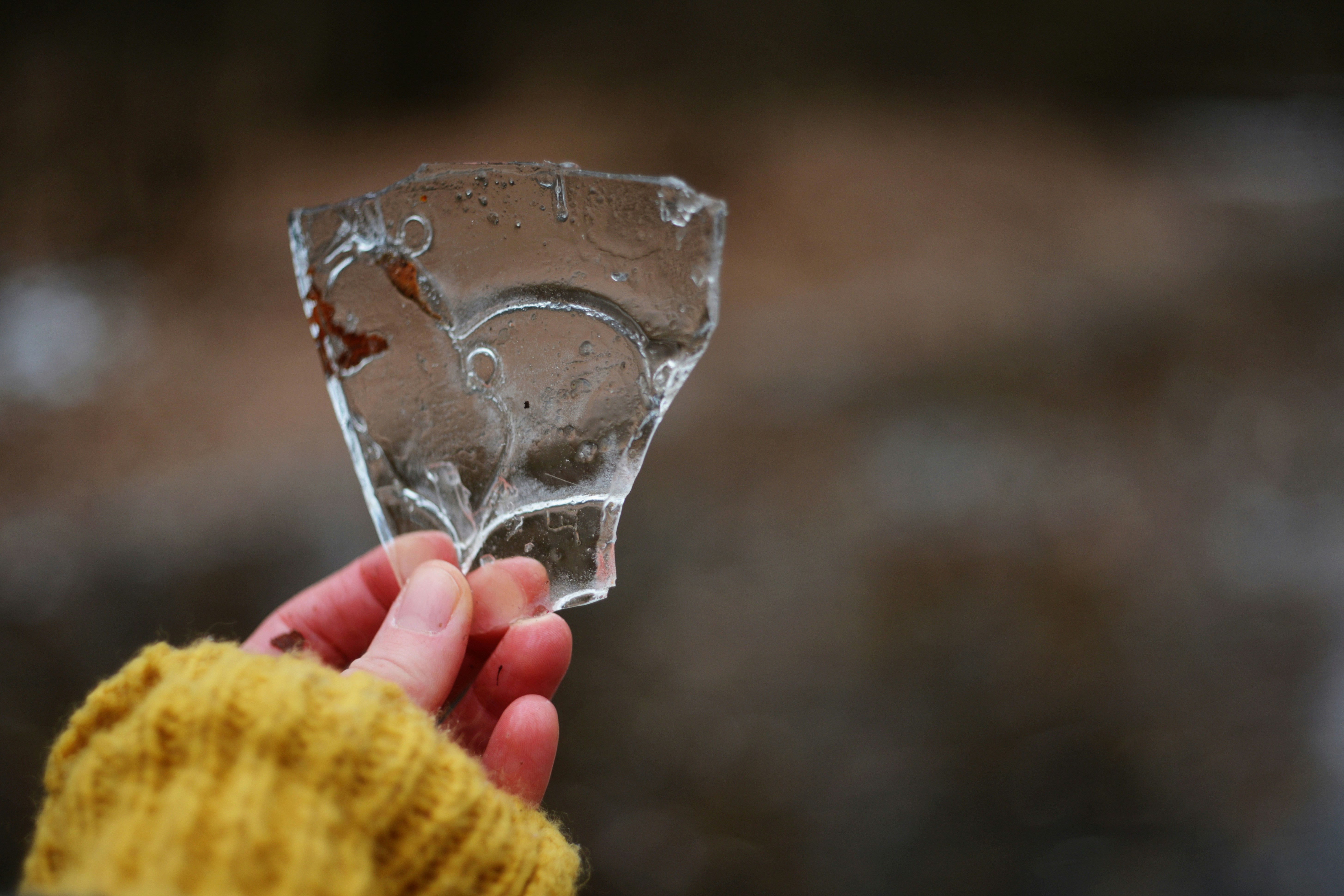 A person holding a piece of ice in their hand