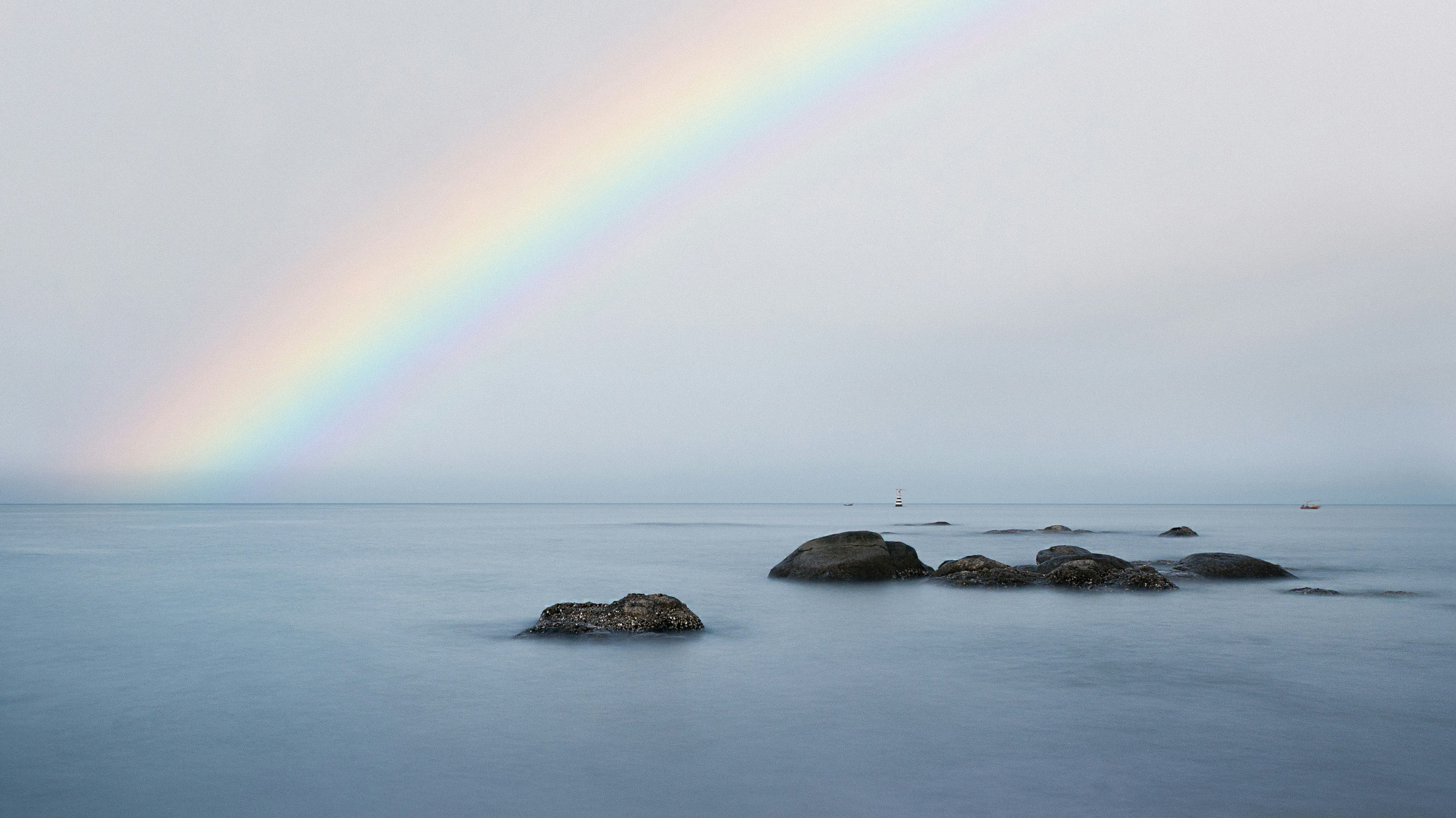 A rainbow in the sky over a body of water