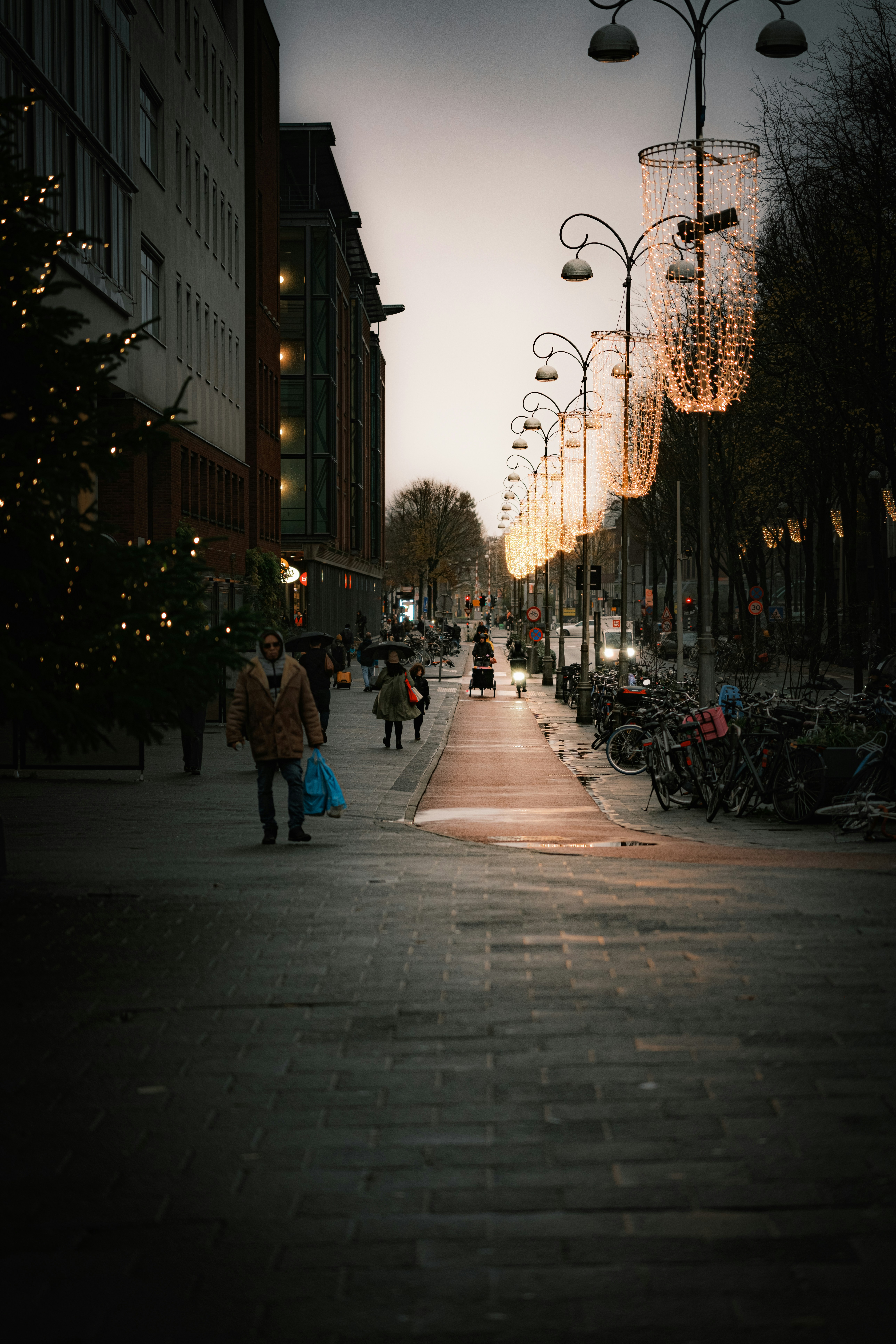 People walking down a sidewalk in a city