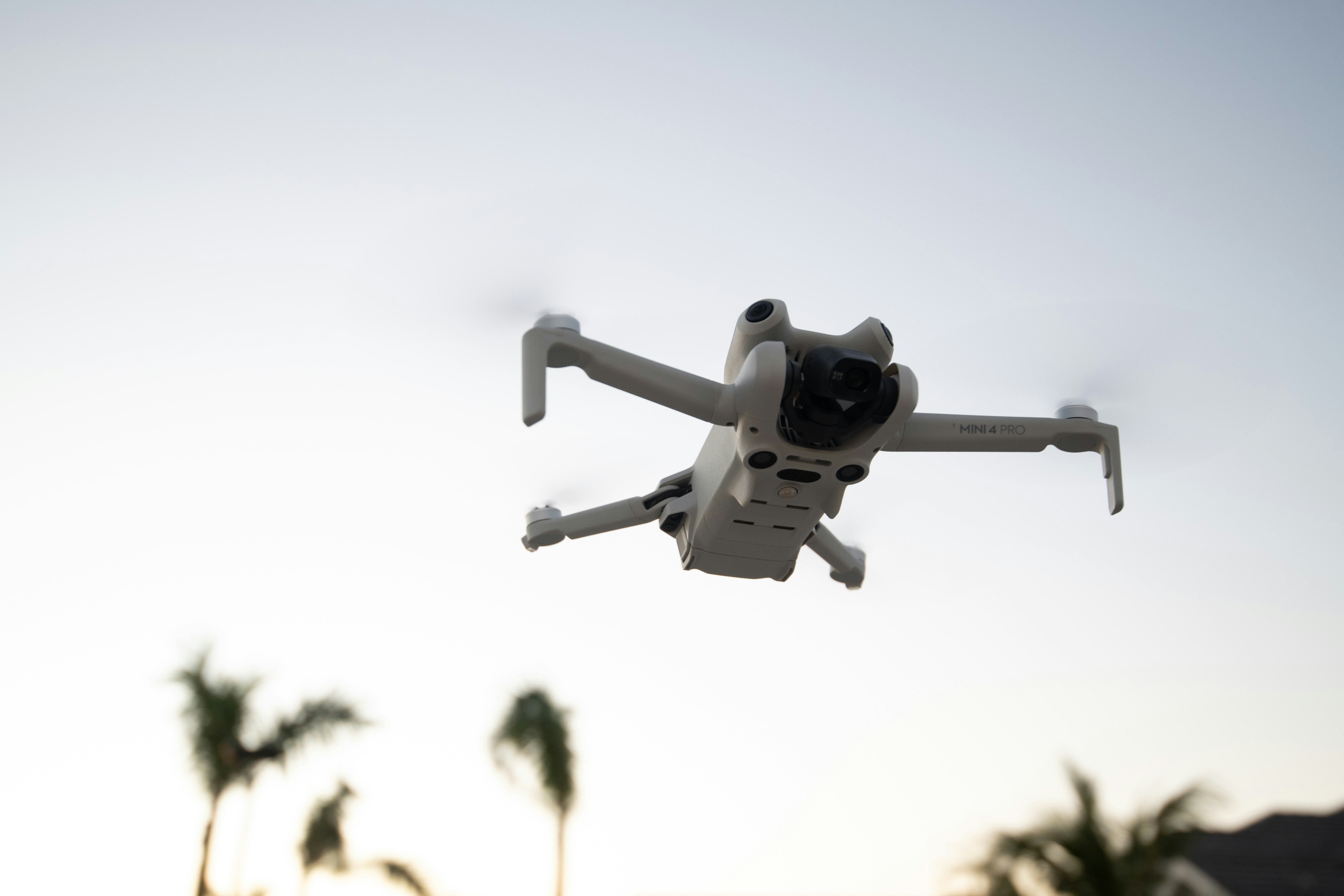 A white and black remote controlled flying in the air