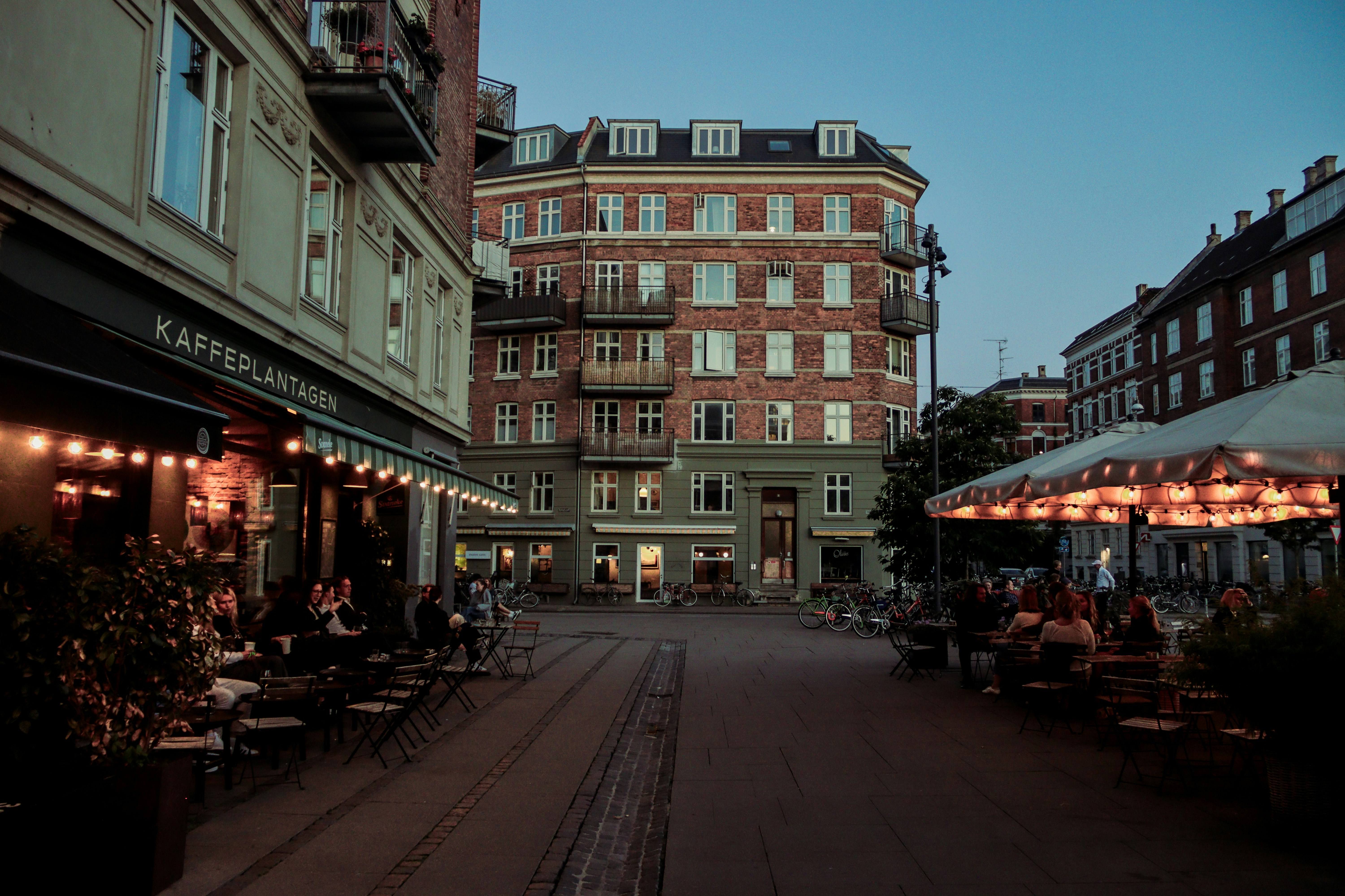 A city street lined with tables and umbrellas