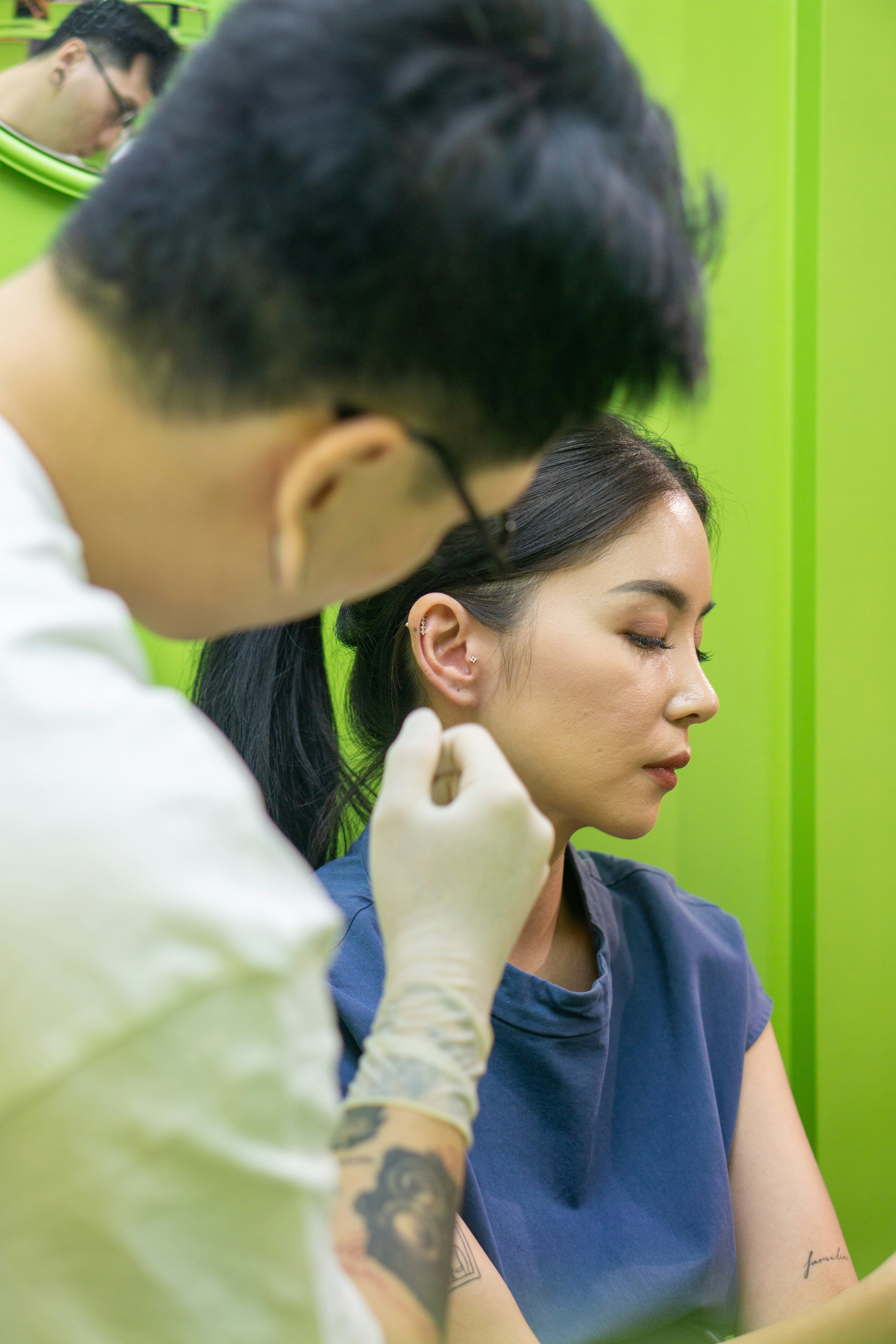 A woman getting her hair done by a man