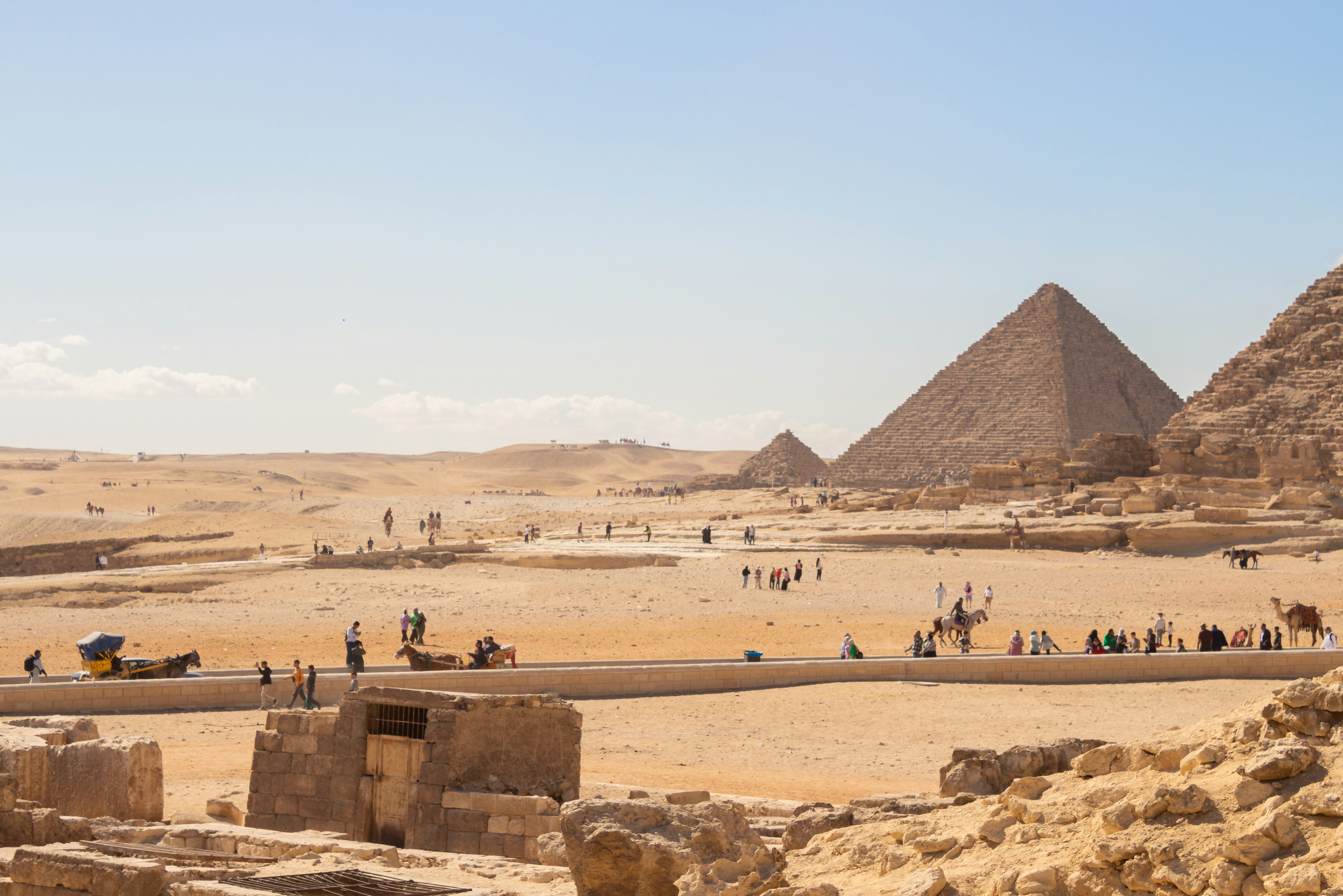 A group of people standing in front of a pyramid