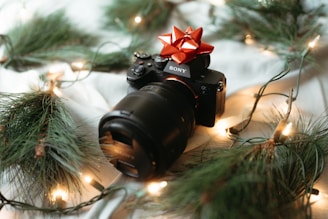 A camera sitting on top of a table covered in christmas lights