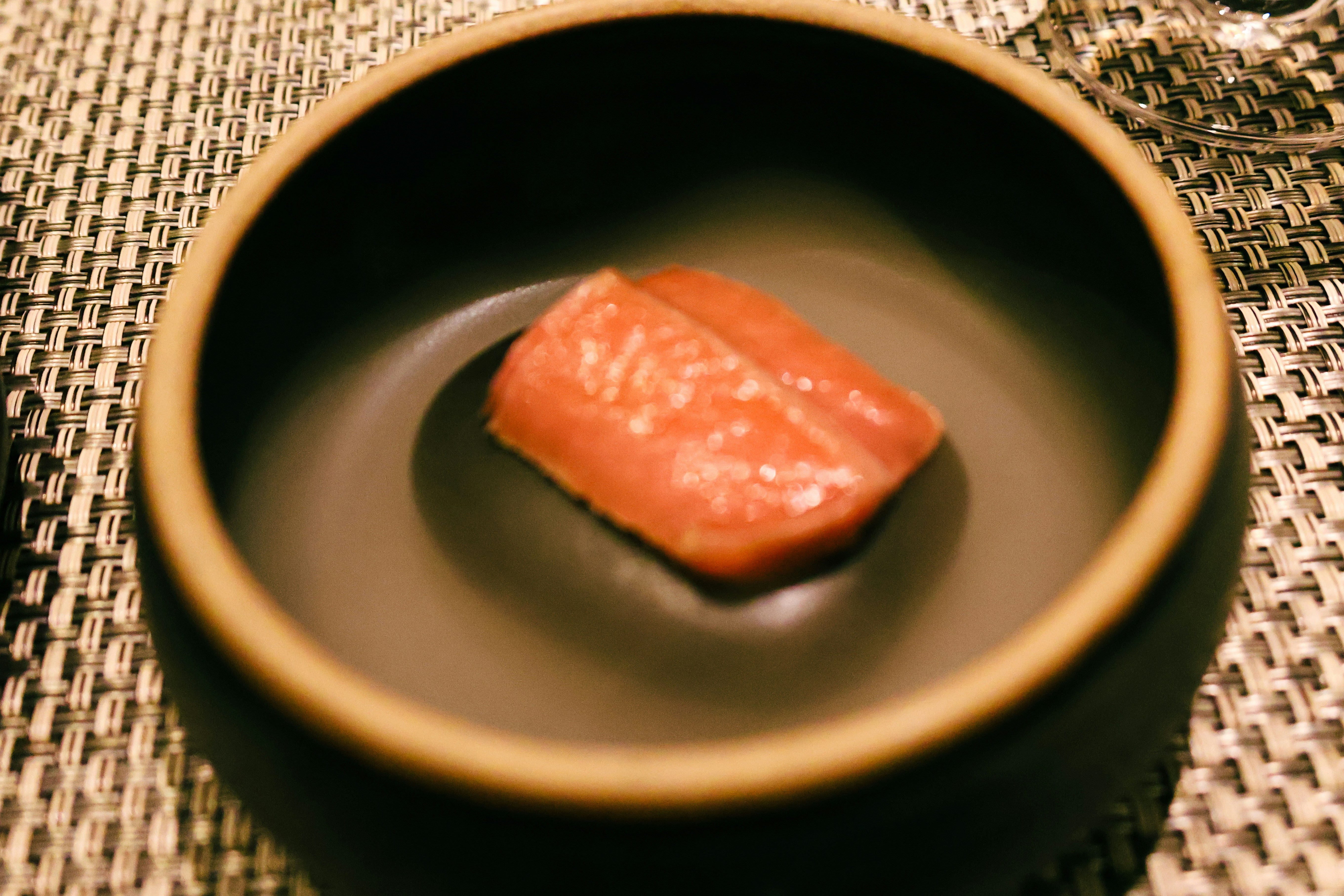 A small piece of food in a bowl on a table