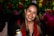 A woman holding a can of beer in her hand
