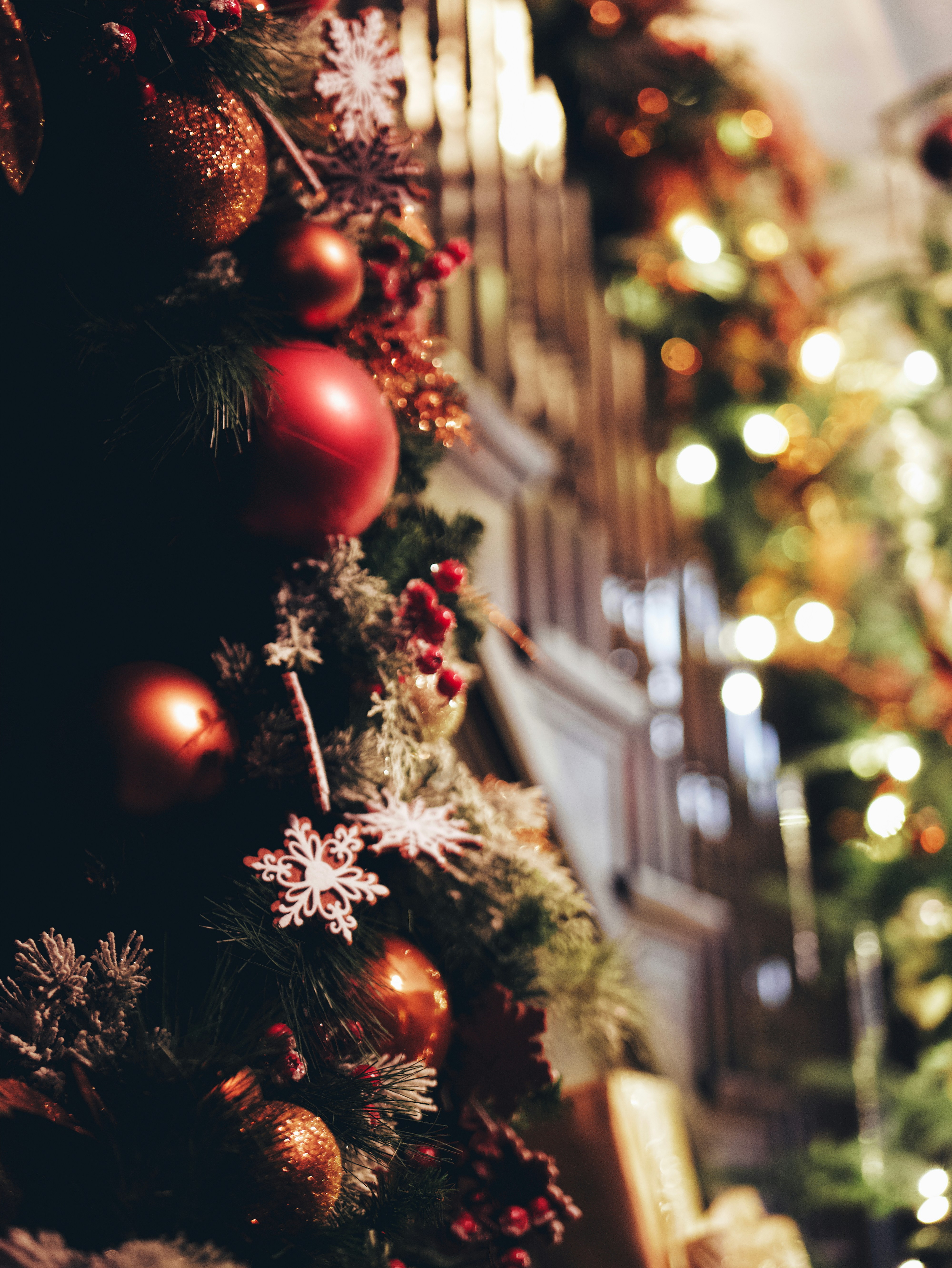 A decorated christmas tree in front of a building