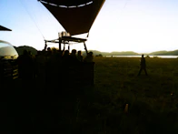 A group of people standing around a hot air balloon