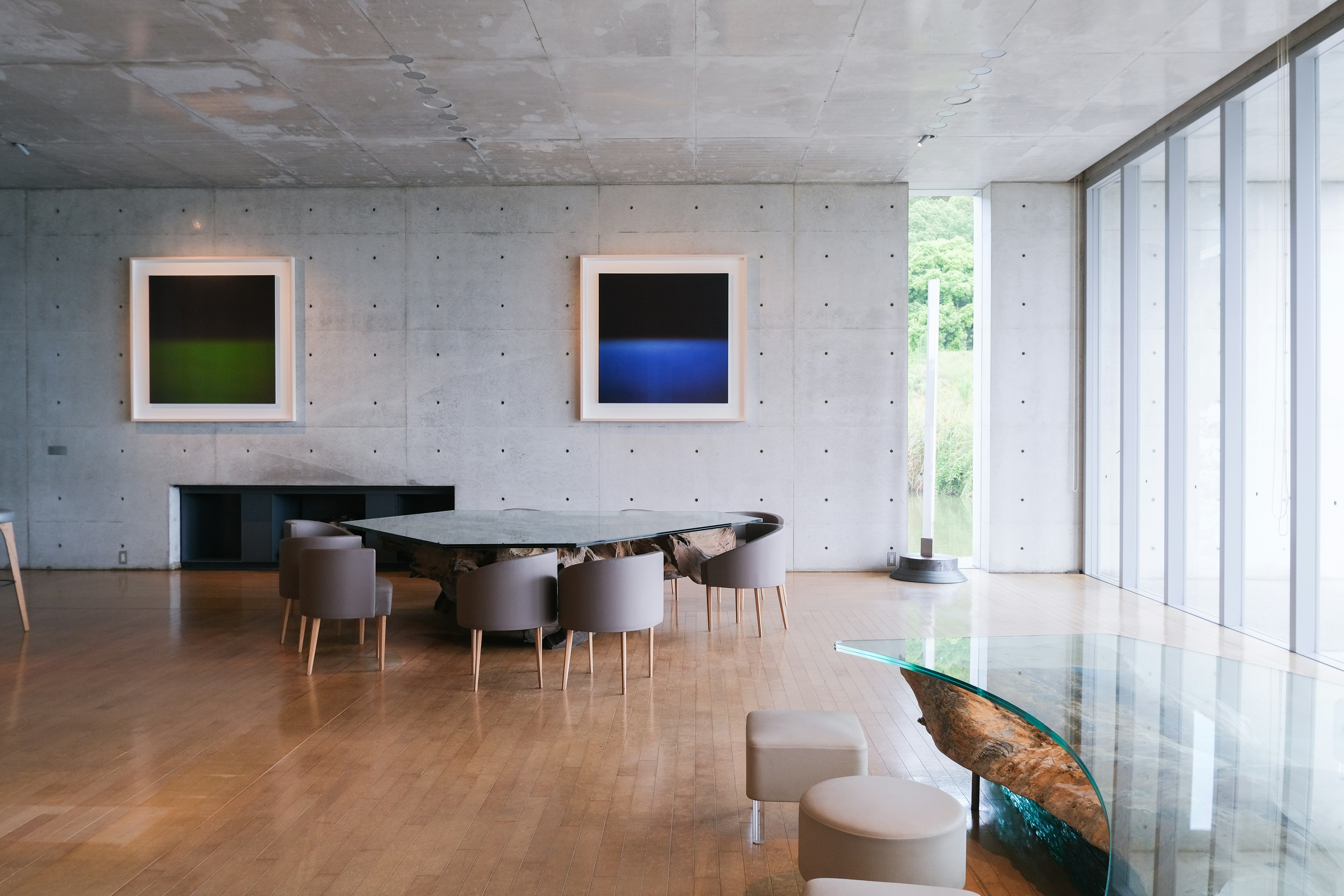 A room with a table, chairs, and pictures on the wall