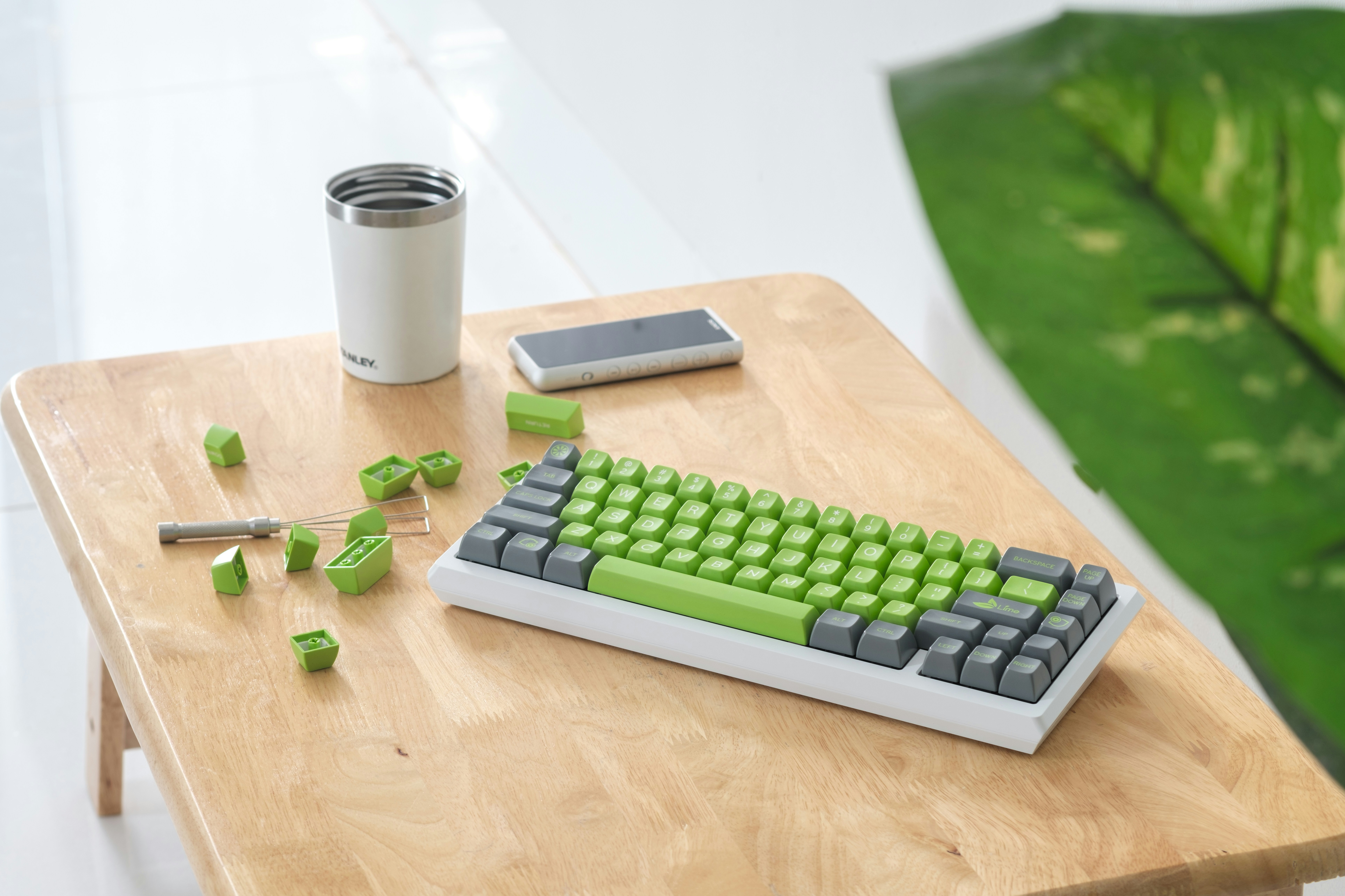 A computer keyboard sitting on top of a wooden table
