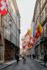 People walking down a street lined with flags