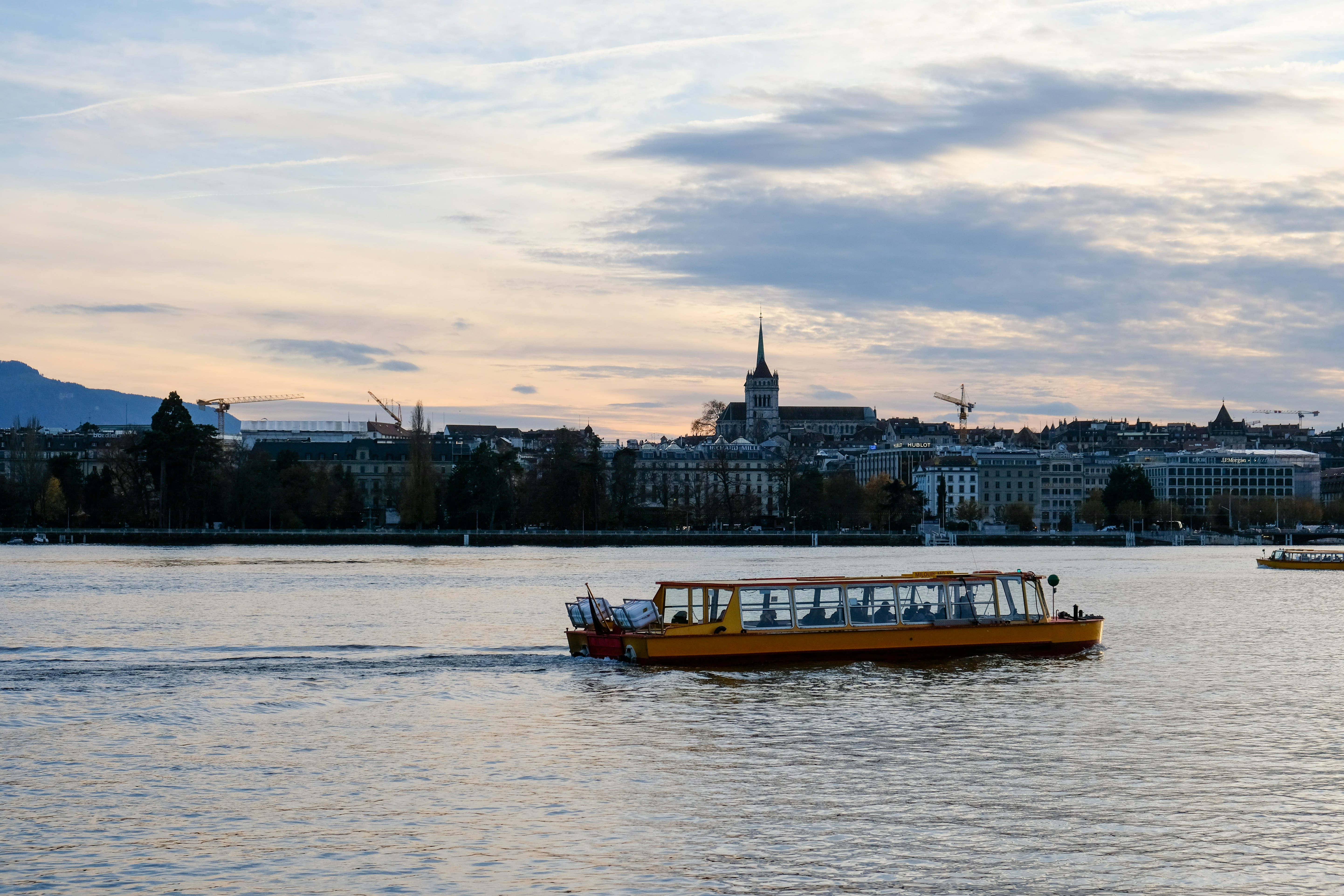 A yellow boat floating on top of a lake