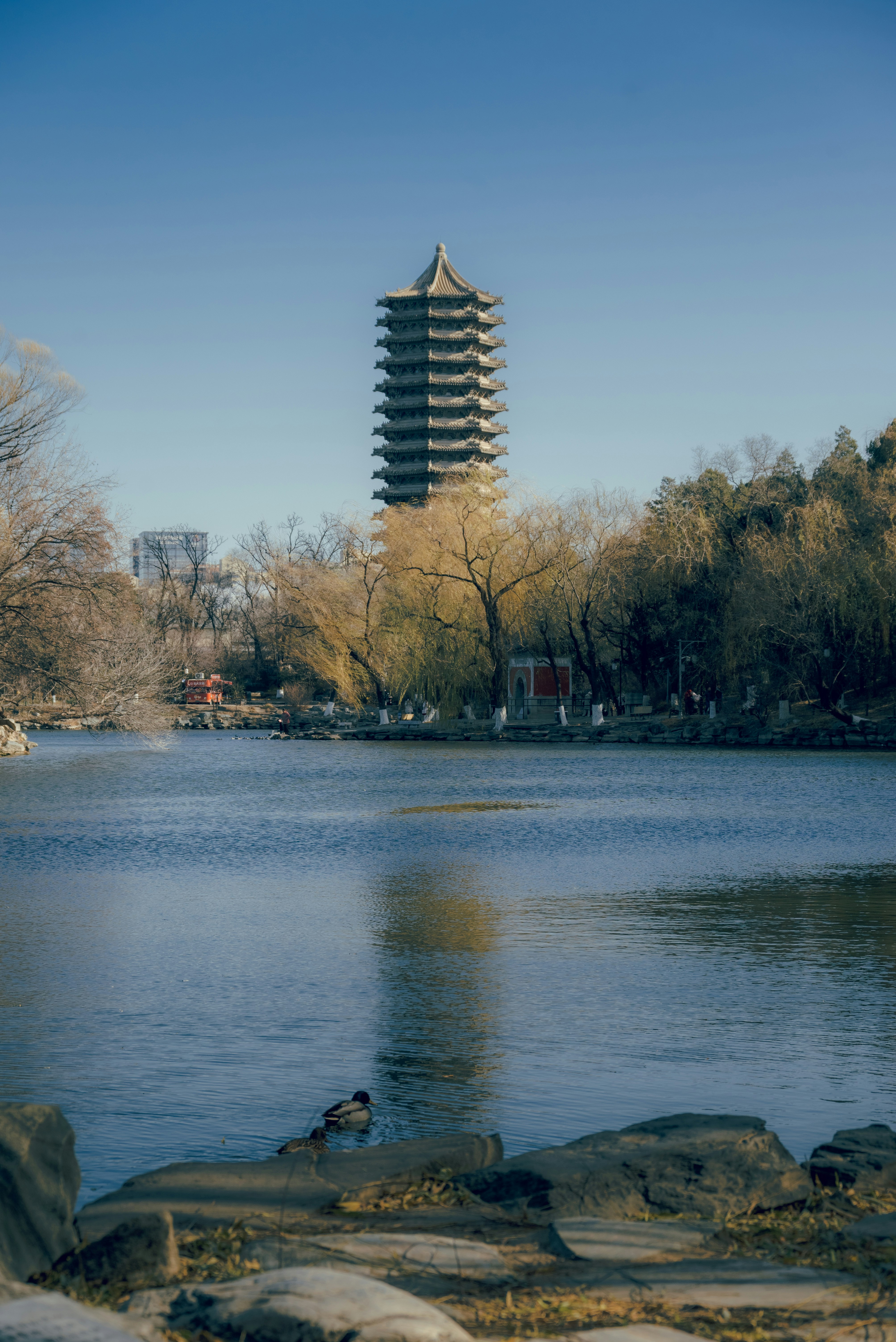A large body of water with a tall tower in the background