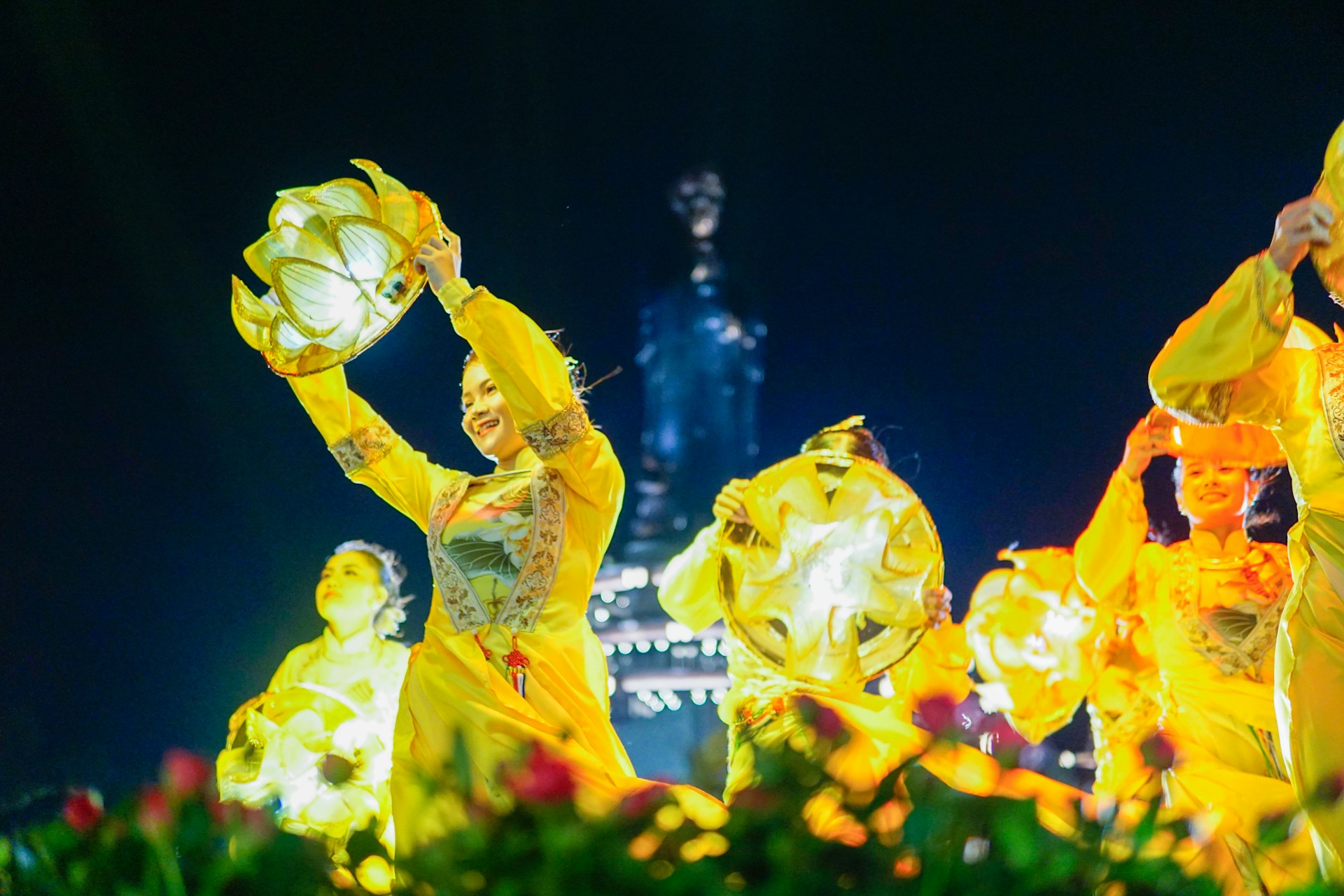 A group of people that are standing in the grass