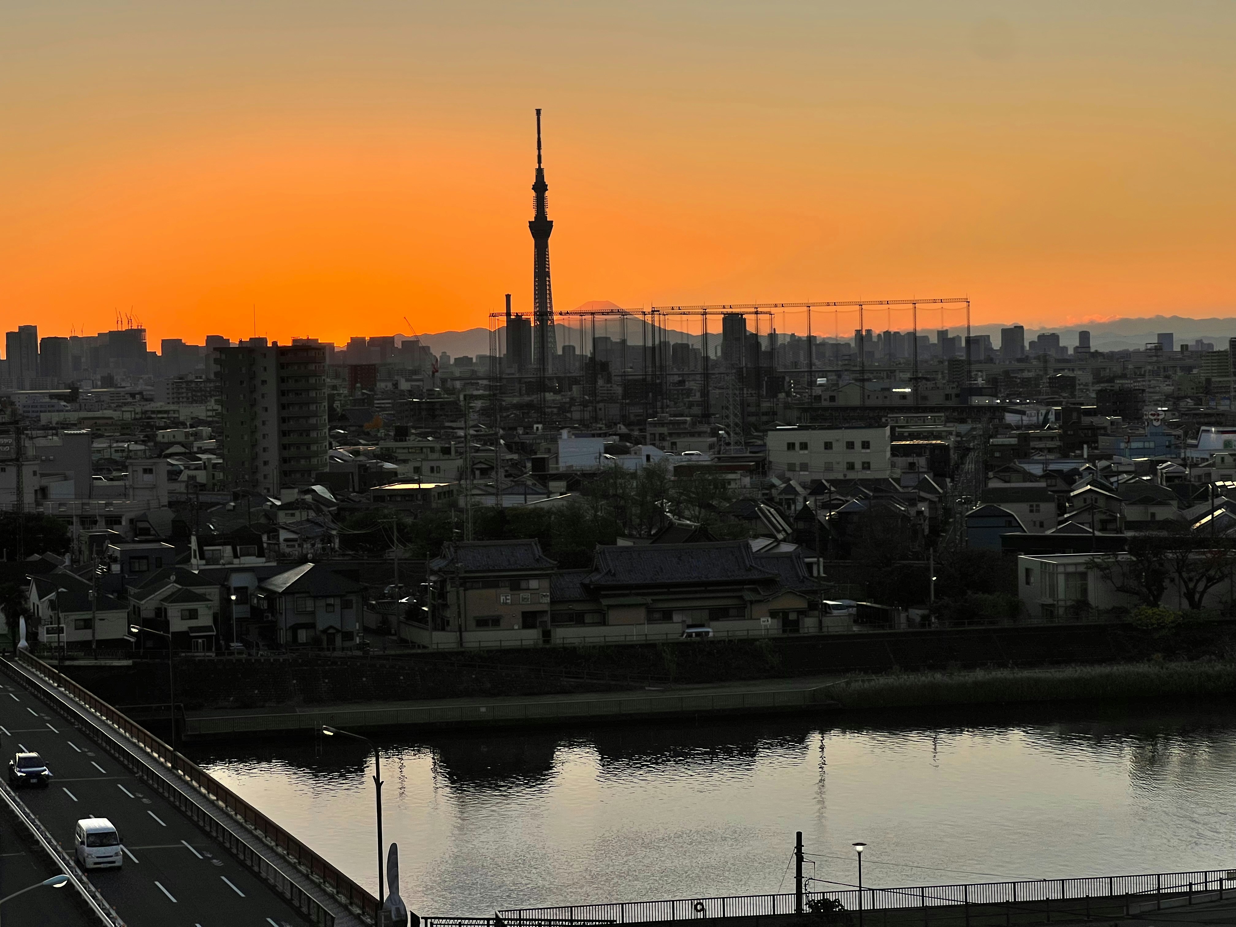 Tokyo night skyline with illuminated skyscrapers and Mount Fuji in background