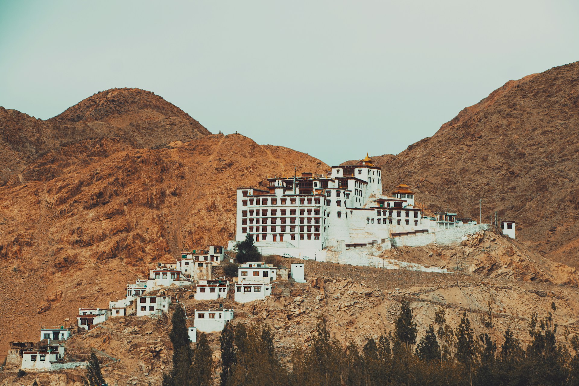 A large white building sitting on top of a mountain