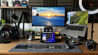 A desk with two monitors and a camera