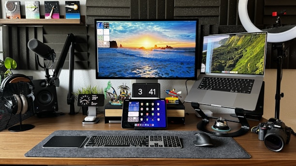 A desk with two monitors and a camera