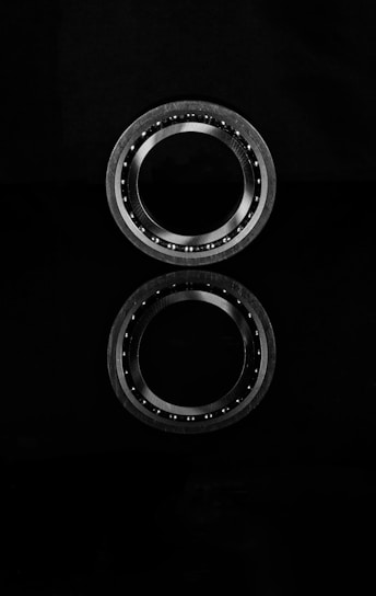 A pair of ball bearing units on a black background