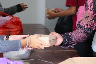 A group of people standing around a table