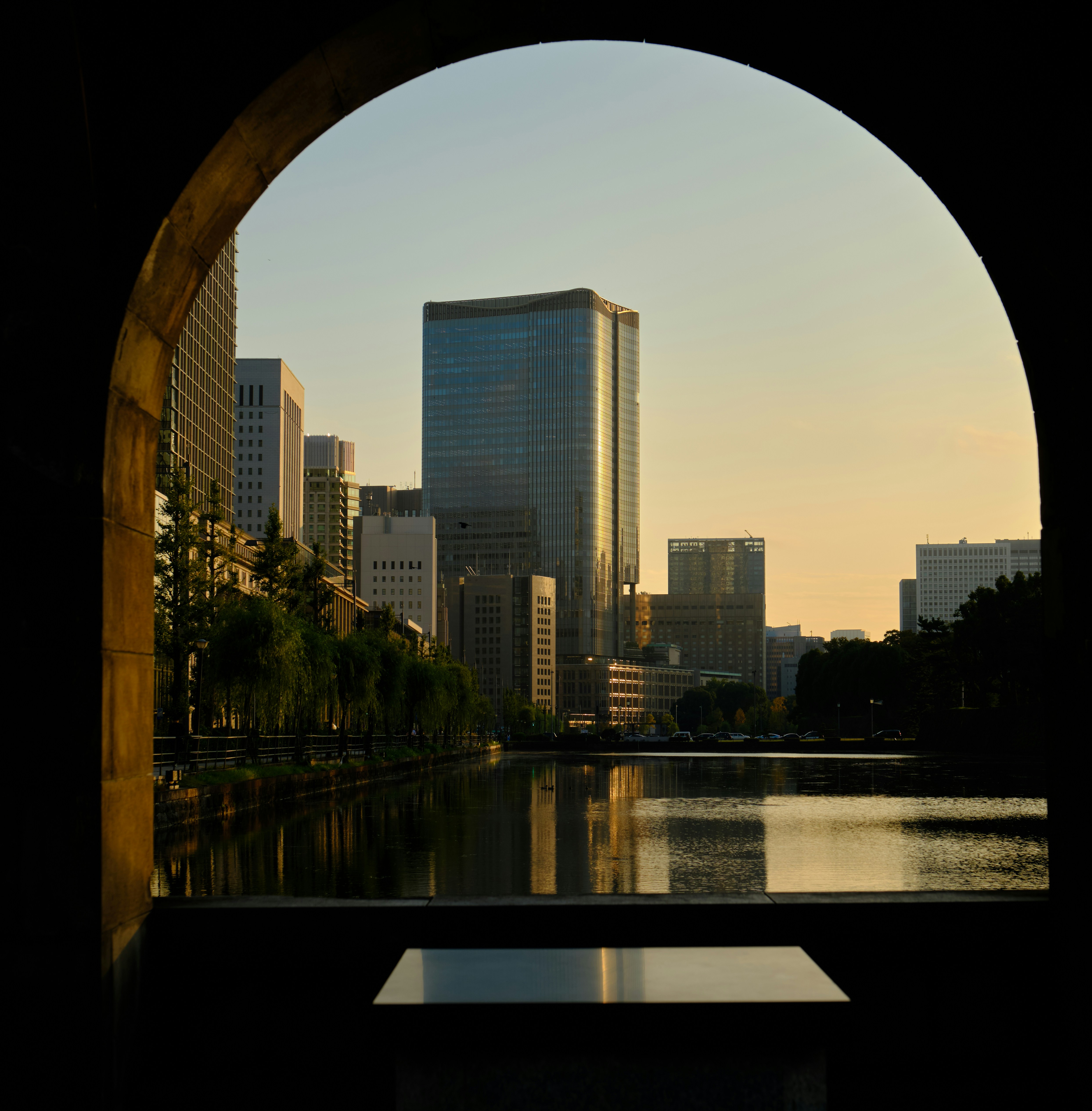 A view of a city through an arch in a building photo – Free Building ...