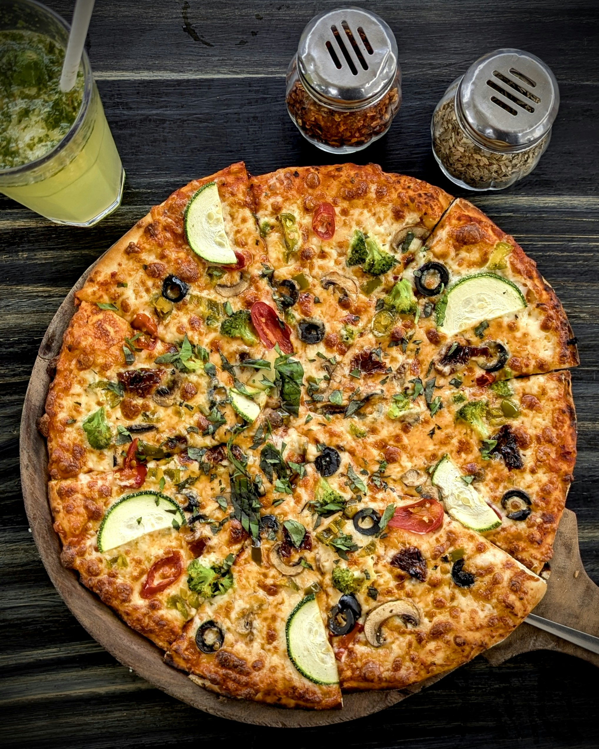 A pizza sitting on top of a wooden cutting board