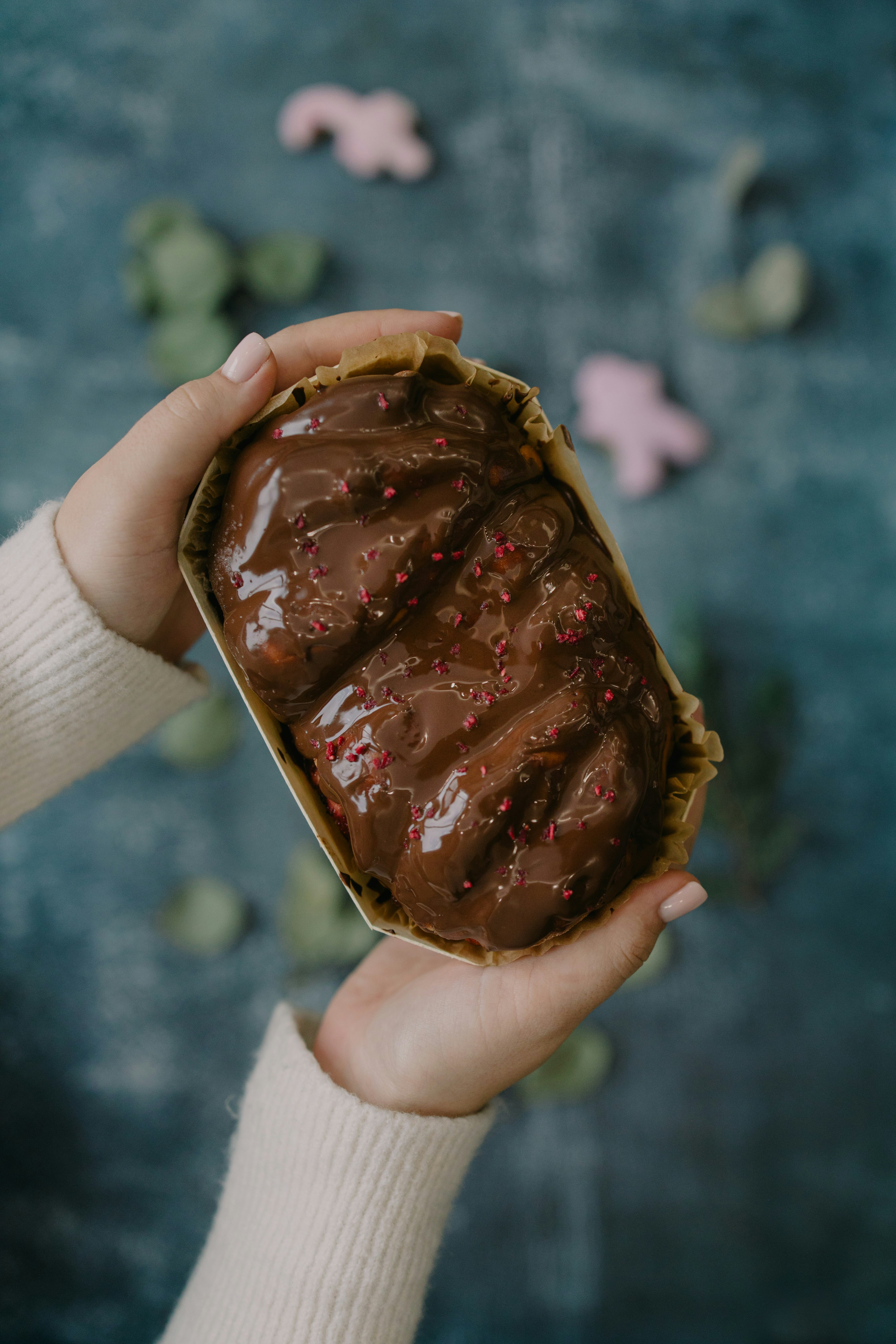 A person holding a piece of cake in their hands