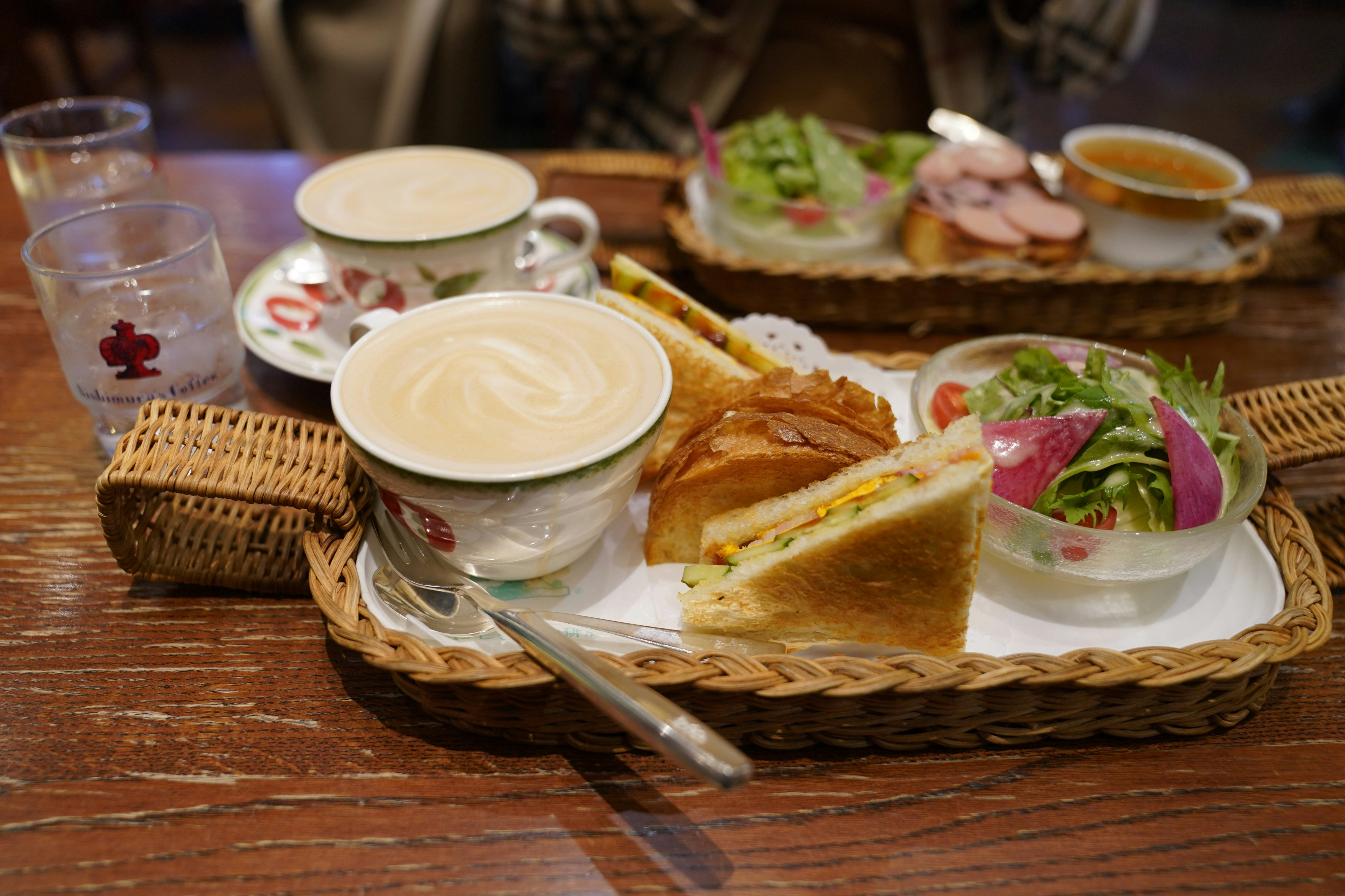 A morning set at a Japanese cafe, featuring hot coffee, thick toast, and a side of hard-boiled egg or salad