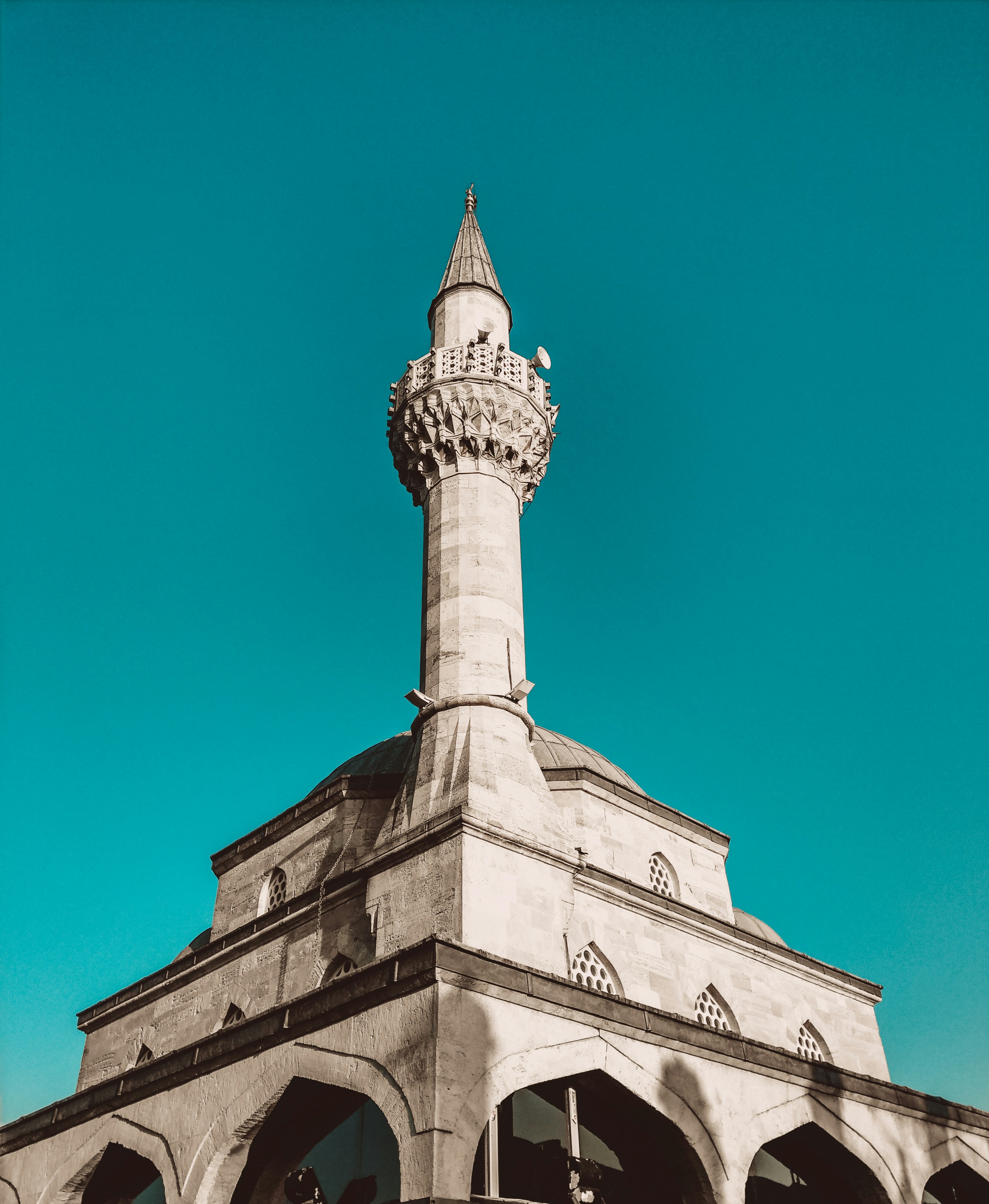 A tall white building with a clock on it's side