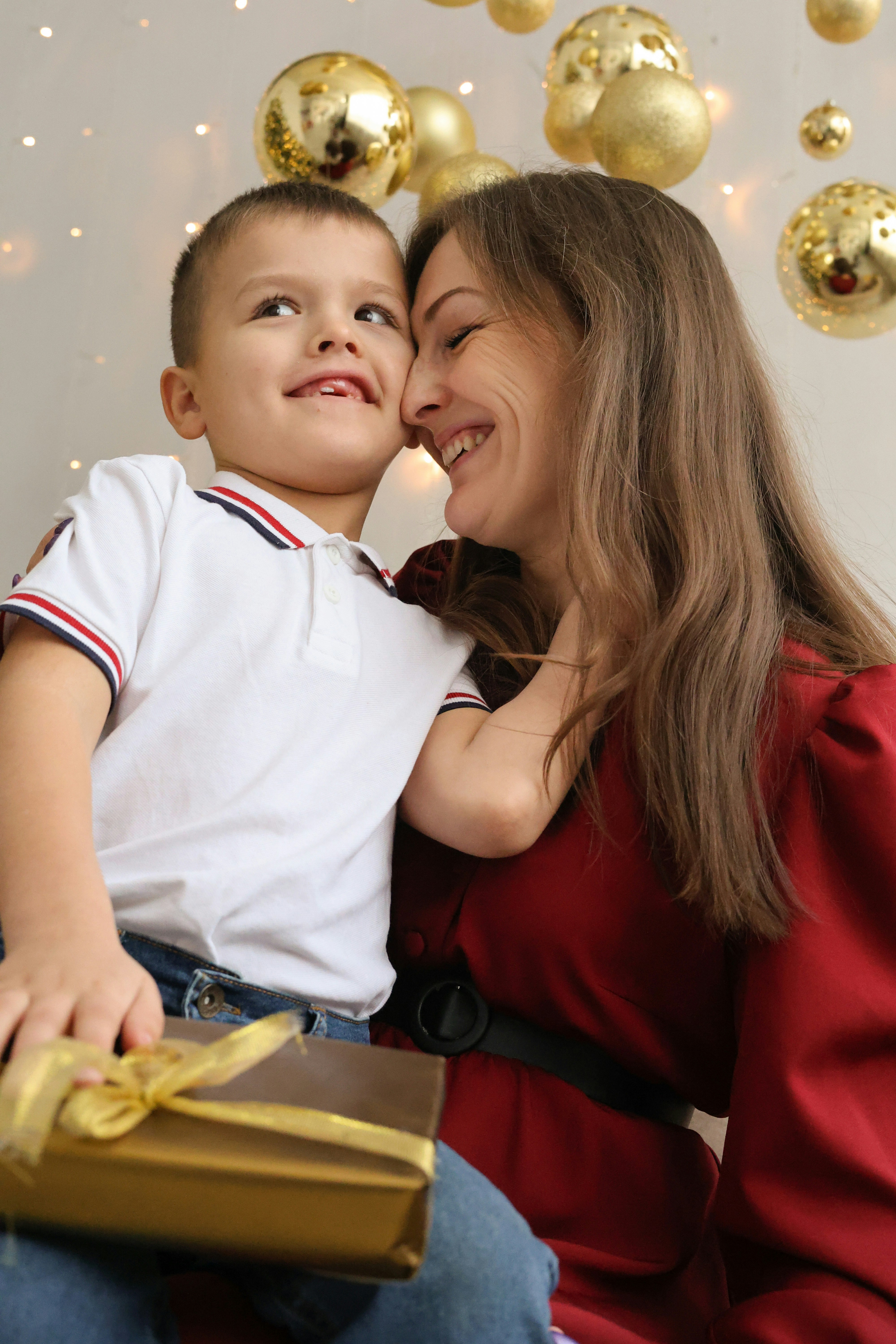 A woman sitting next to a little boy