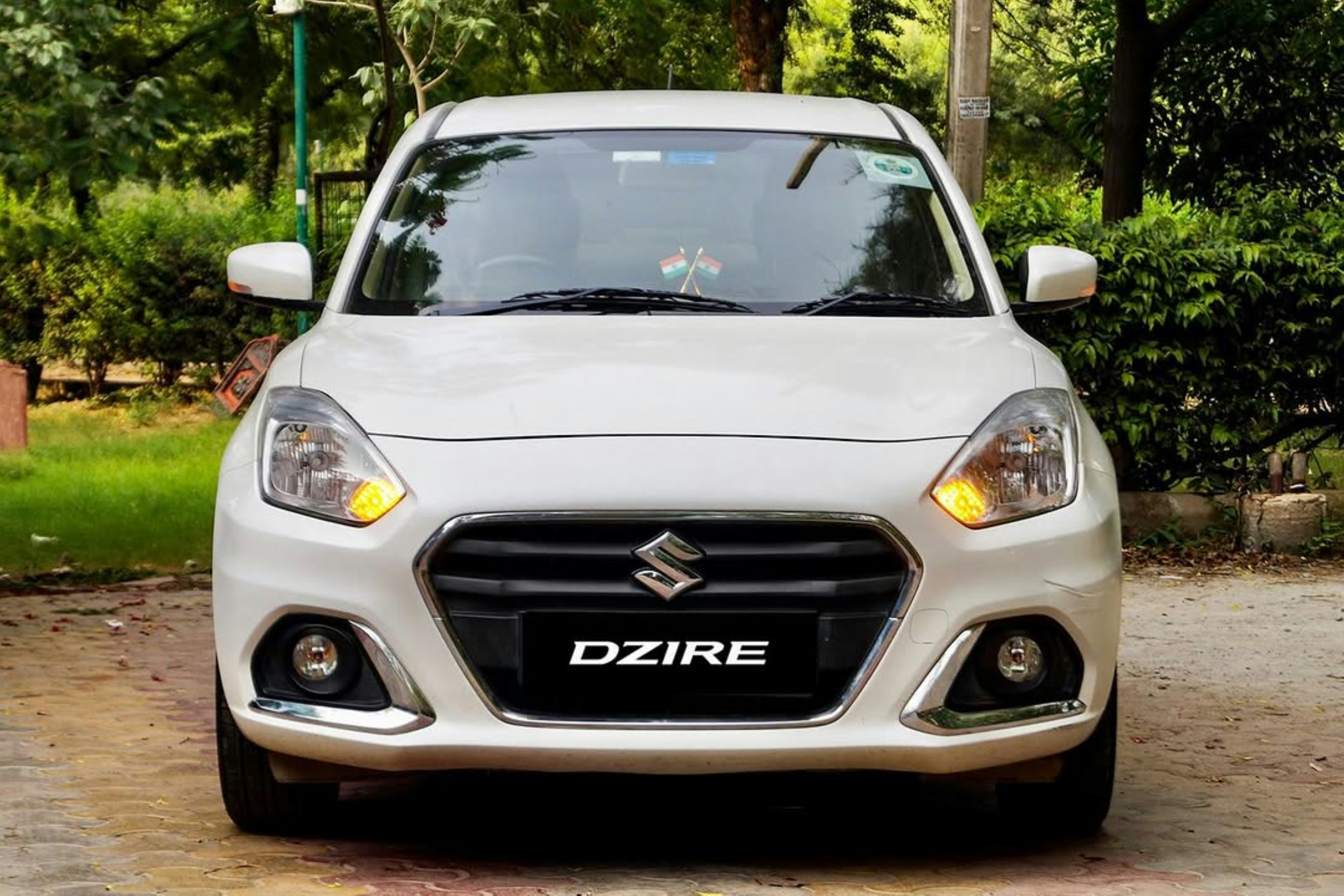 Maruti Suzuki Dzire sedan taxi in white color