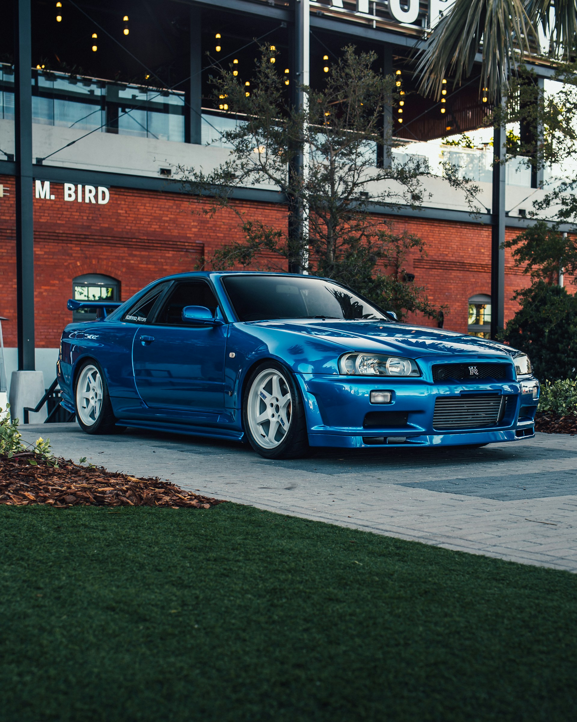 A blue car parked in front of a building