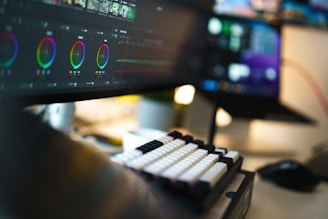 A close up of a computer monitor with a keyboard and mouse