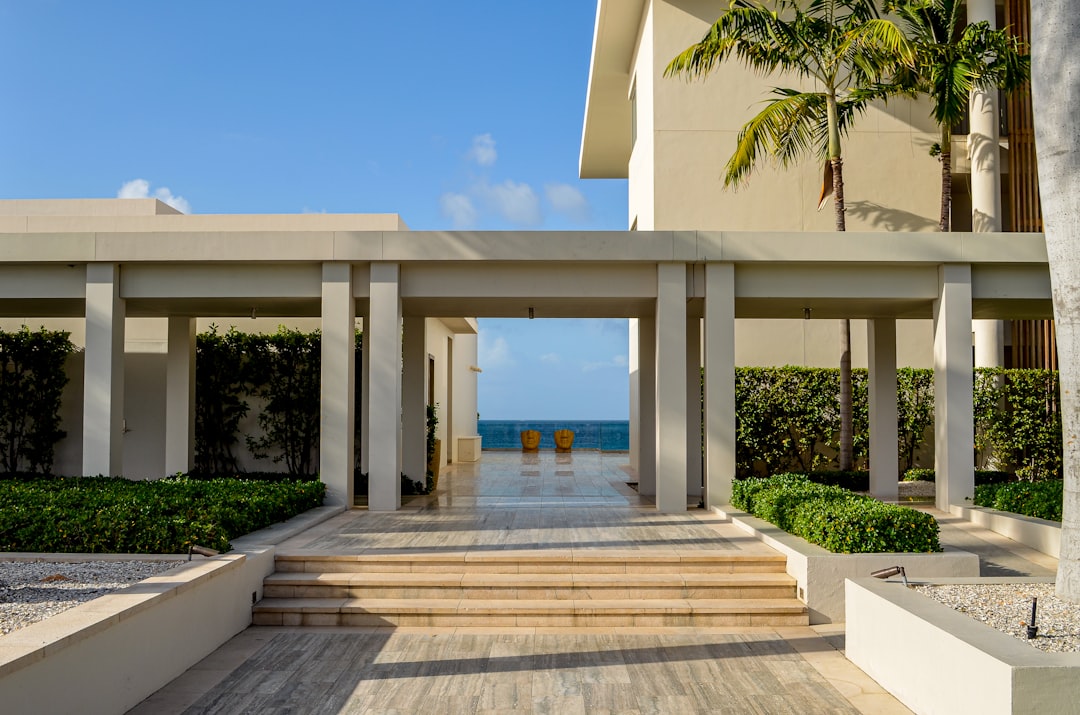 A large building with steps leading to the beach,