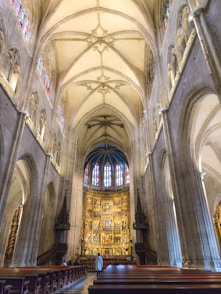 A large cathedral with pews and stained glass windows
