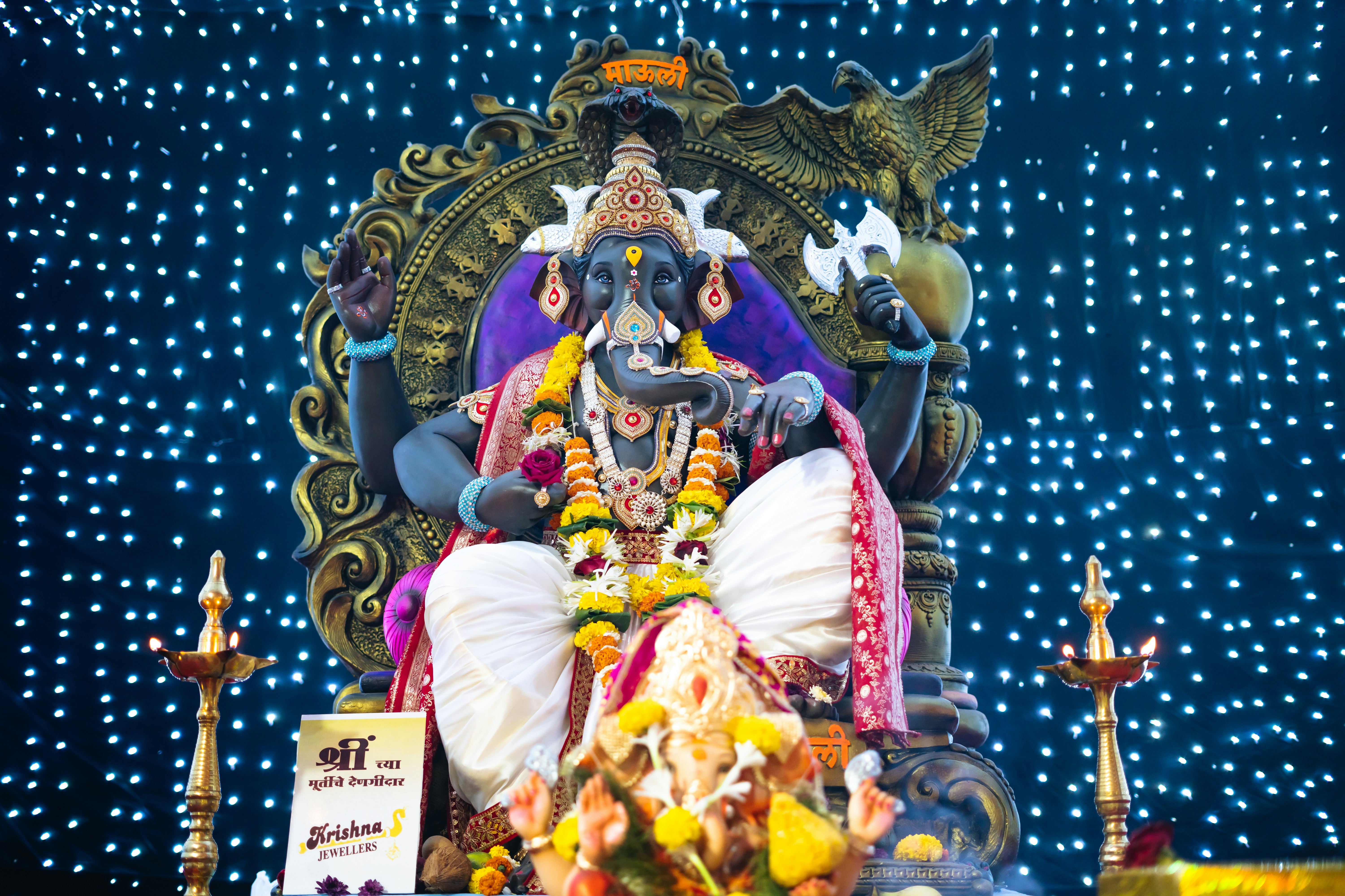 A statue of lord ganesh in front of a blue background