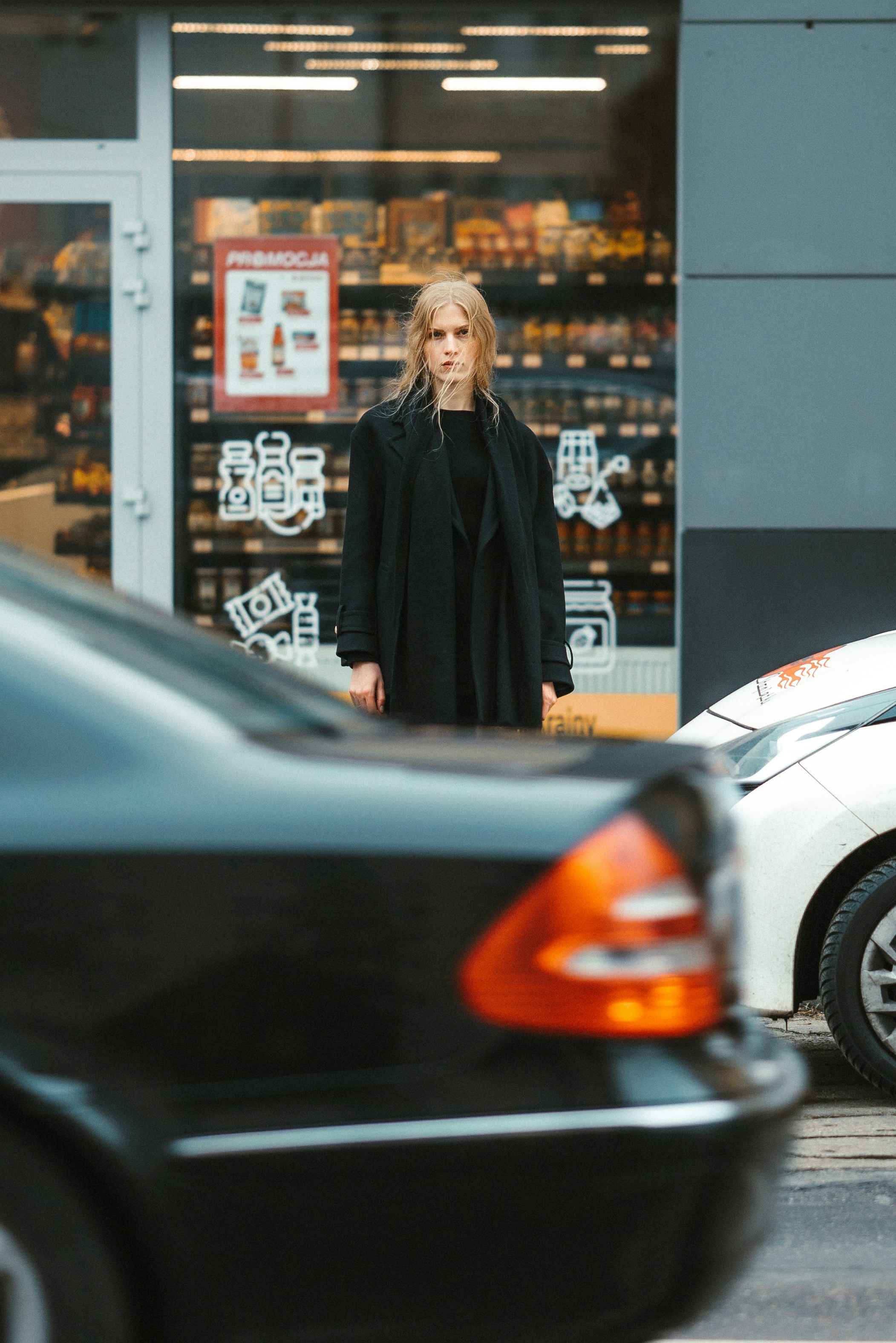 A woman standing in front of a store
