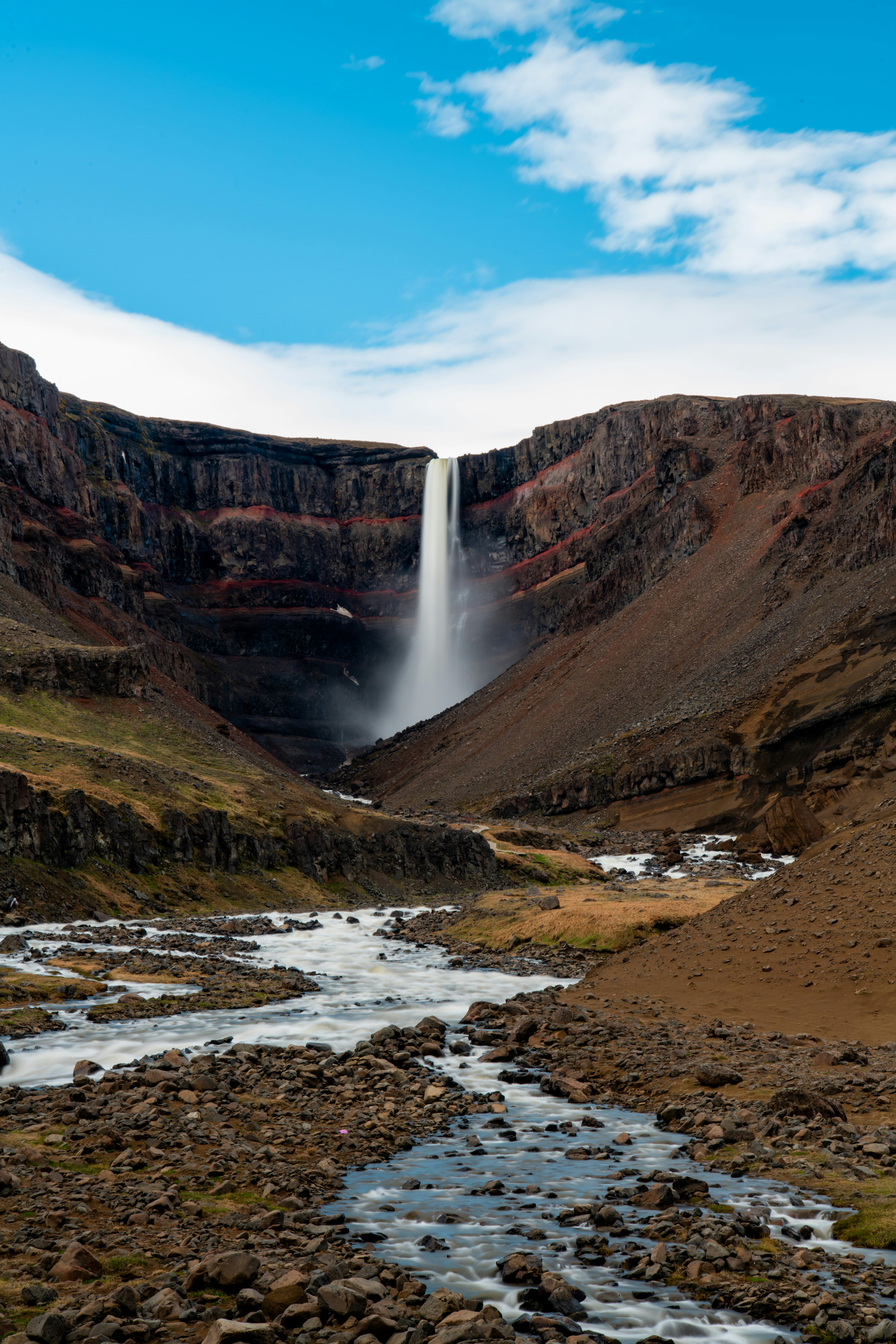 A view of a waterfall in the middle of a valley